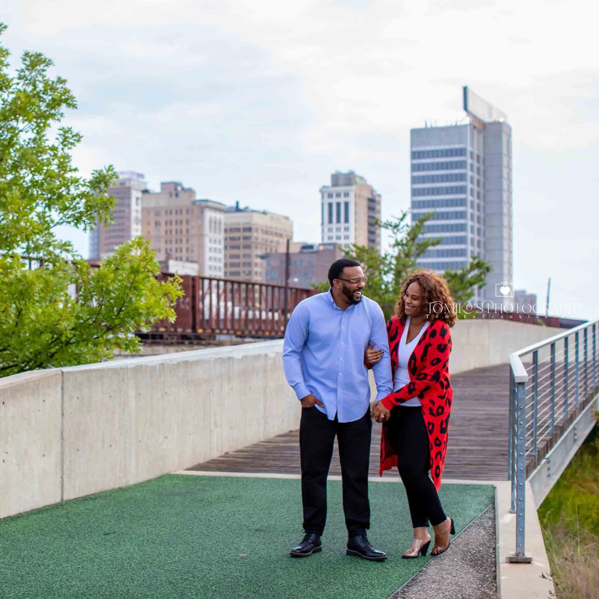Romantic engagement session with a couple sitting together at Railroad Park during sunset in Birmingham AL.