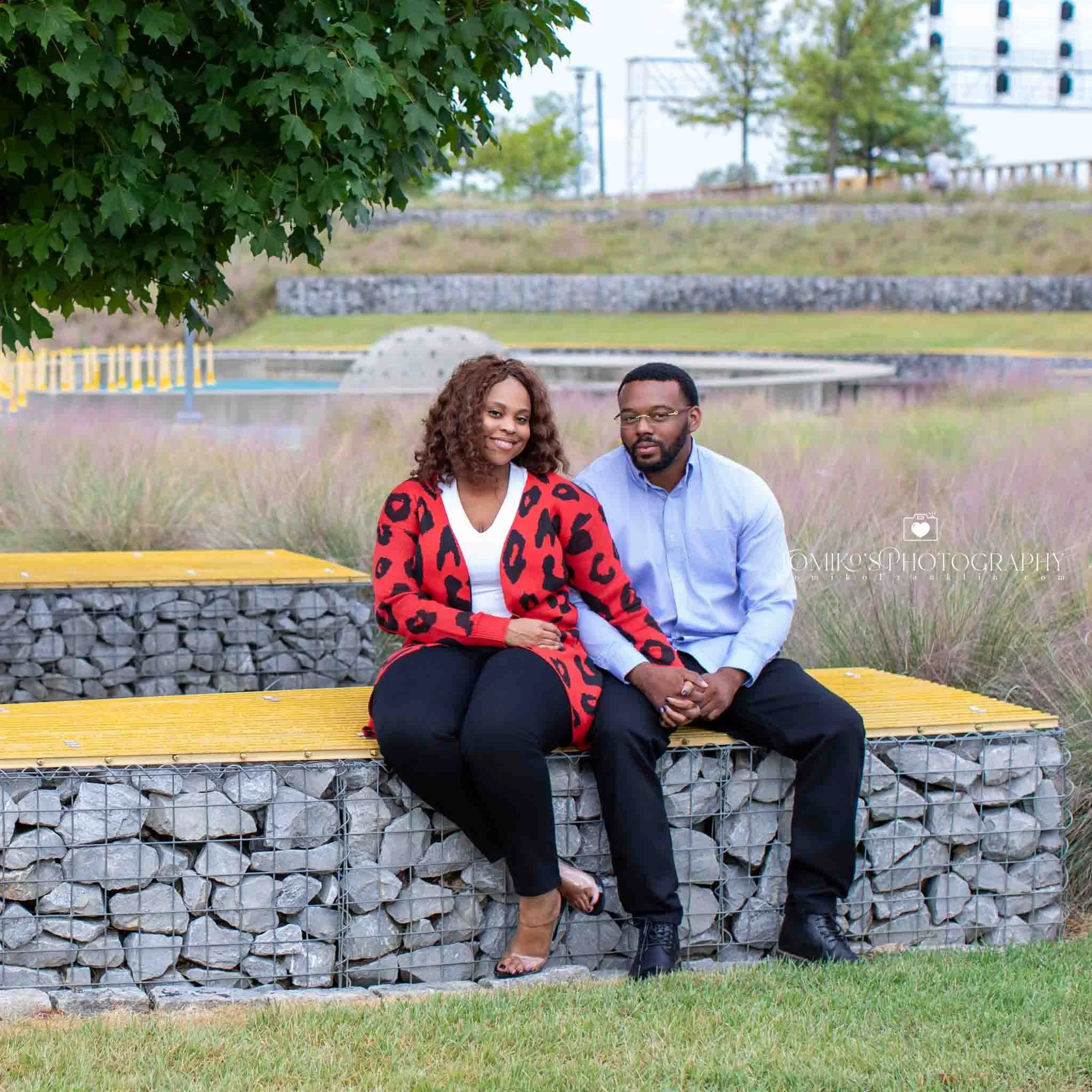 Romantic engagement photo of a Birmingham couple embracing at sunset in Railroad Park with warm luxury editing.