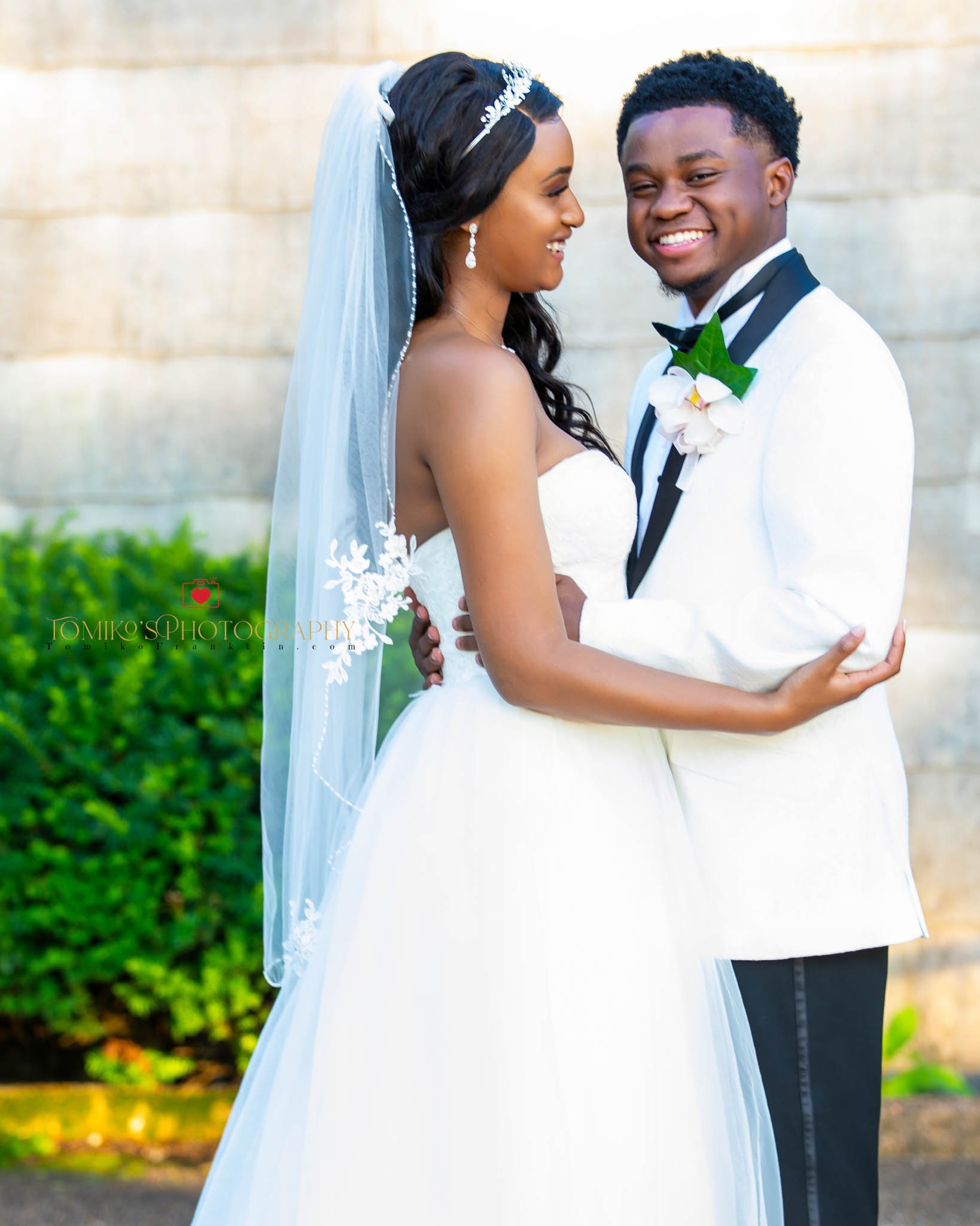 Happy newlywed couple posing for their bride and groom portrait, smiling and embracing on their wedding day, captured by an Alabama wedding photographer specializing in elegant, timeless wedding imagery.