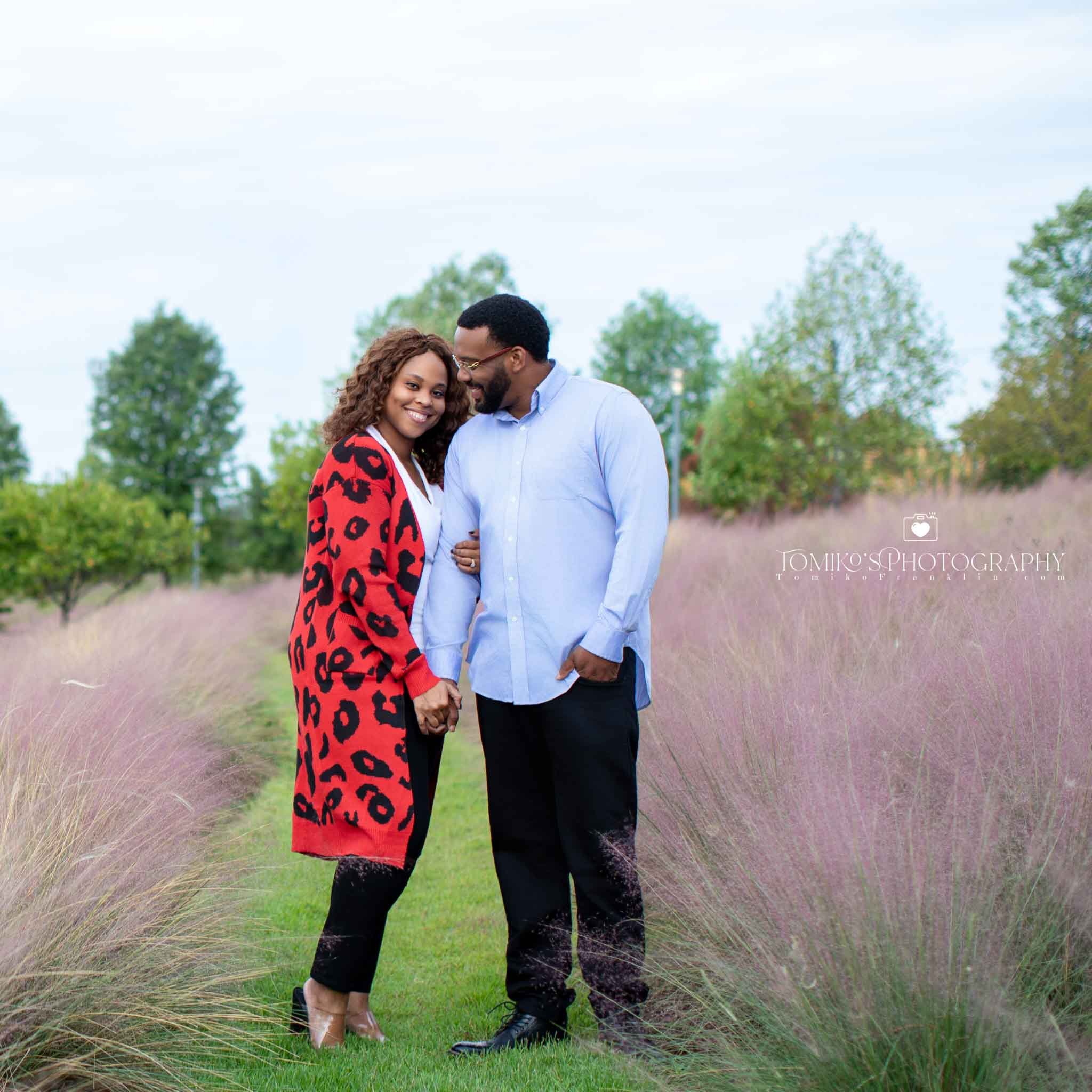 Engagement photographer capturing a couple on a Birmingham rooftop with sweeping city views at sunset.