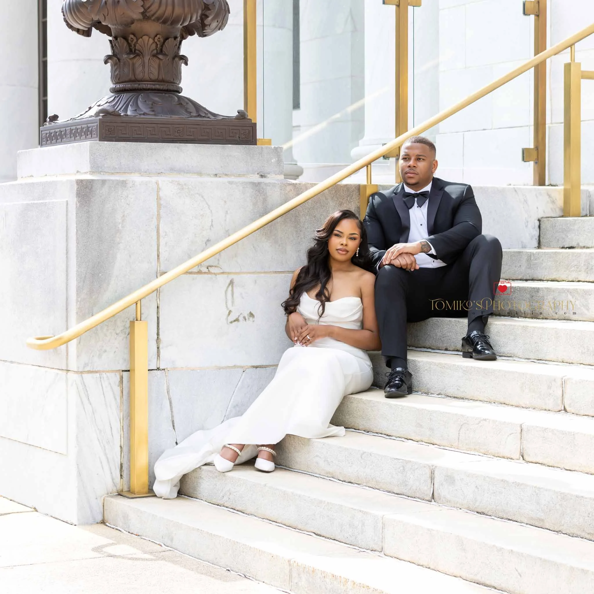 Documentary‑style elopement photo of a couple holding hands in downtown Birmingham.