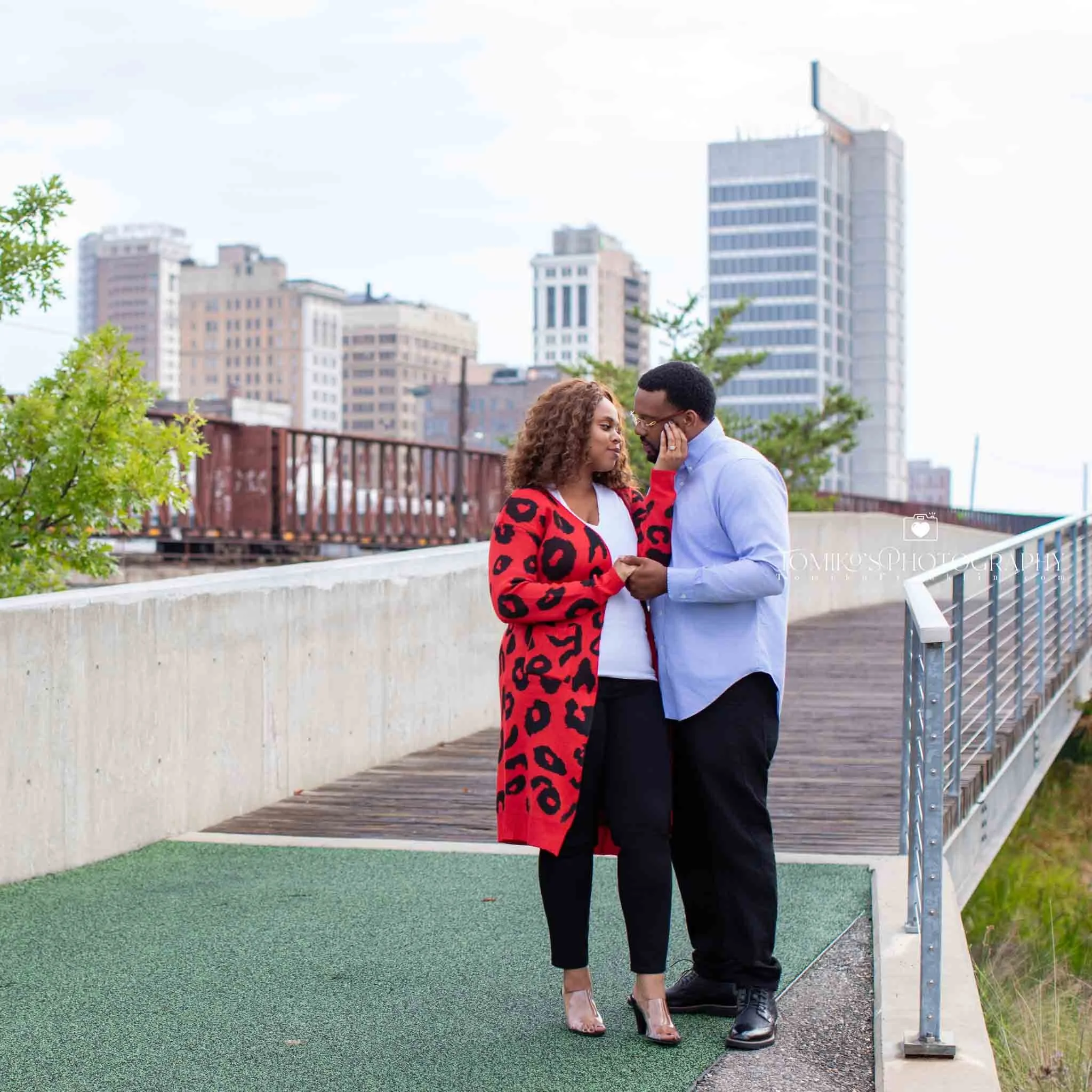 Golden hour engagement session at Railroad Park featuring a couple laughing together, photographed in Birmingham AL.