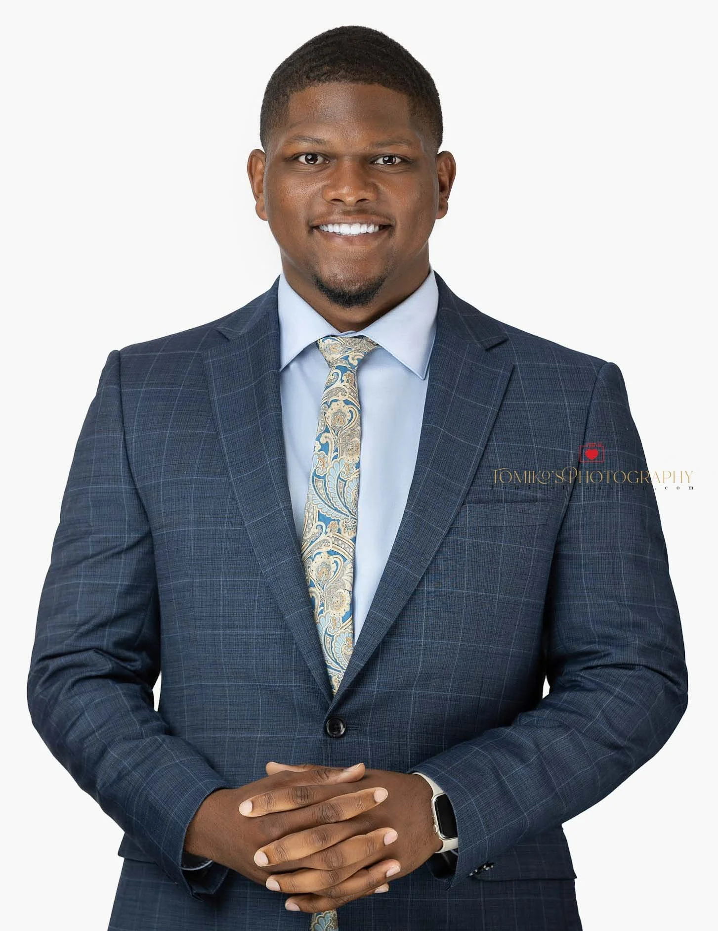 Event photo booth headshot of a man posing on a white background, captured at a professional event with a friendly and approachable expression.