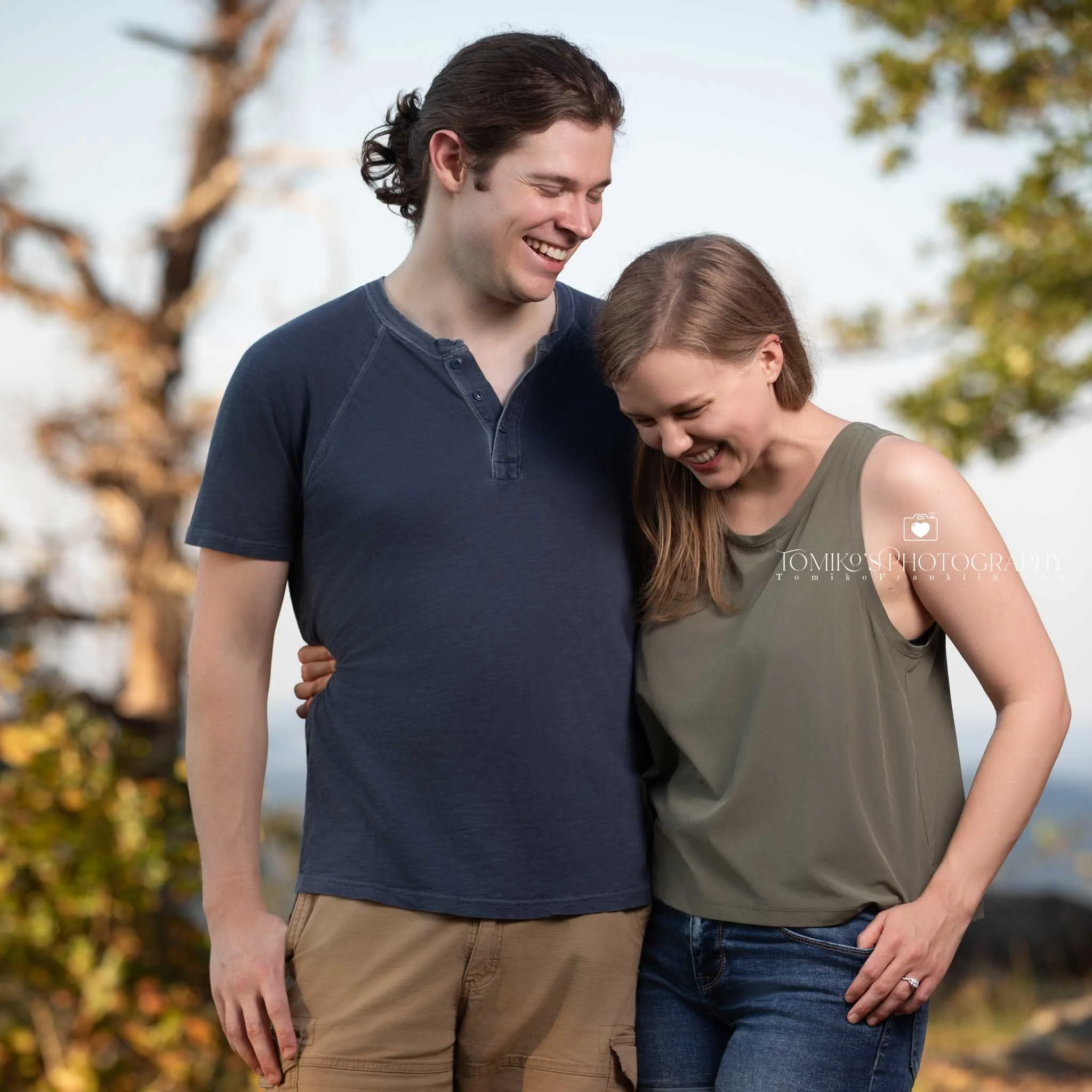Couple celebrating after a surprise proposal at Oak Mountain State Park with luxury portrait styling.

