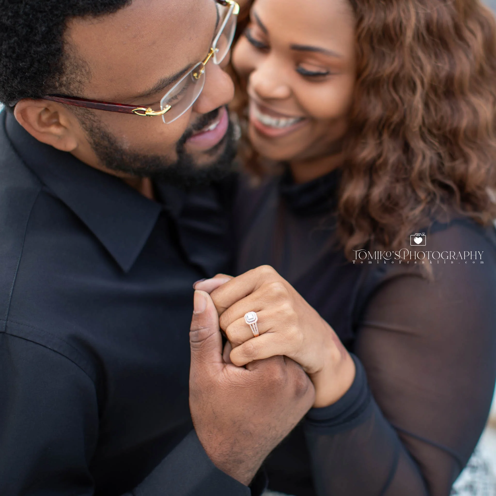 Alabama engagement photos of a couple holding hands on a rooftop with warm golden hour tones.