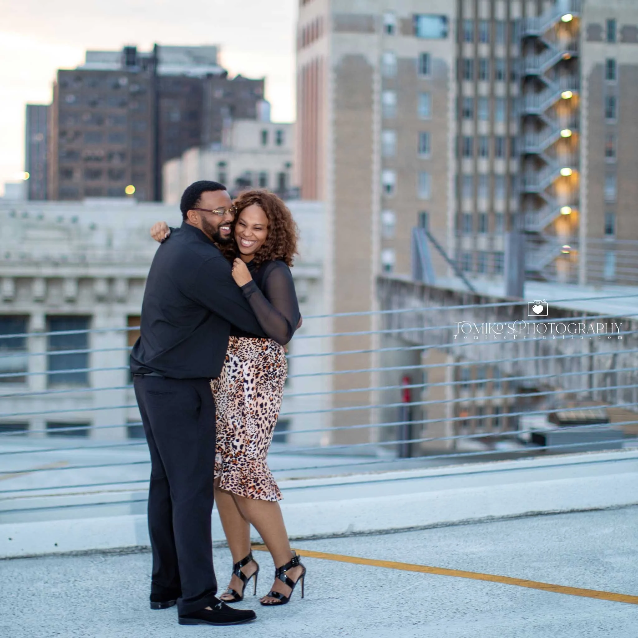Modern engagement portrait of a couple standing in golden light at Railroad Park in Birmingham, Alabama.