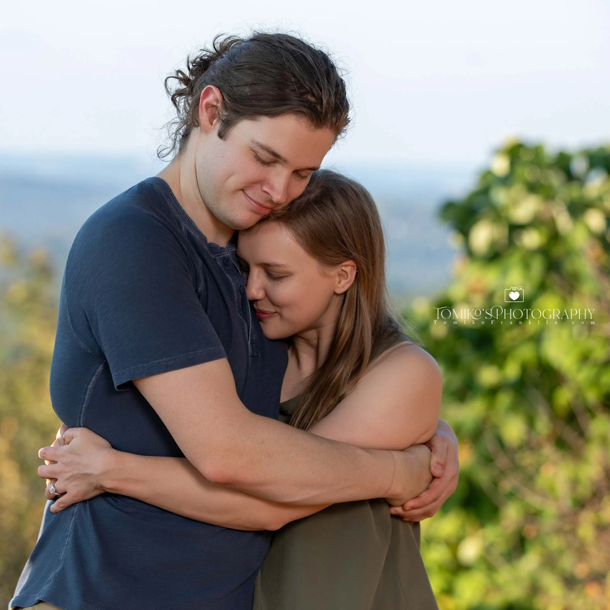 Emotional engagement moment captured at Oak Mountain’s lakeside during a surprise proposal.