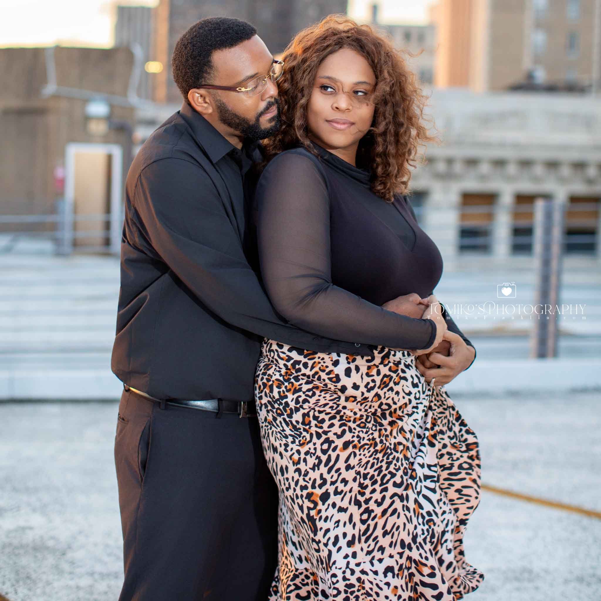 Couple sharing a quiet moment during their engagement session at Railroad Park, photographed in warm sunset tones.