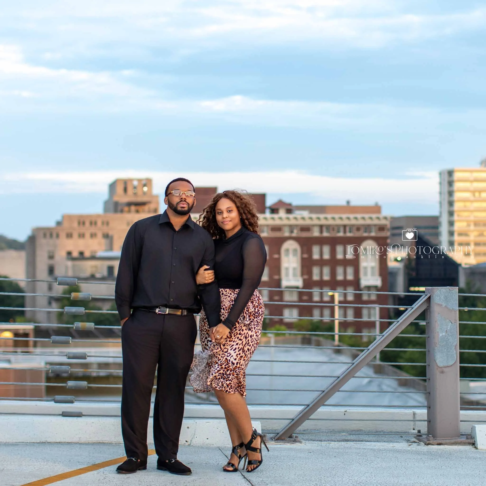 Birmingham engagement photos of a couple posing in golden hour light with greenery at Railroad Park.