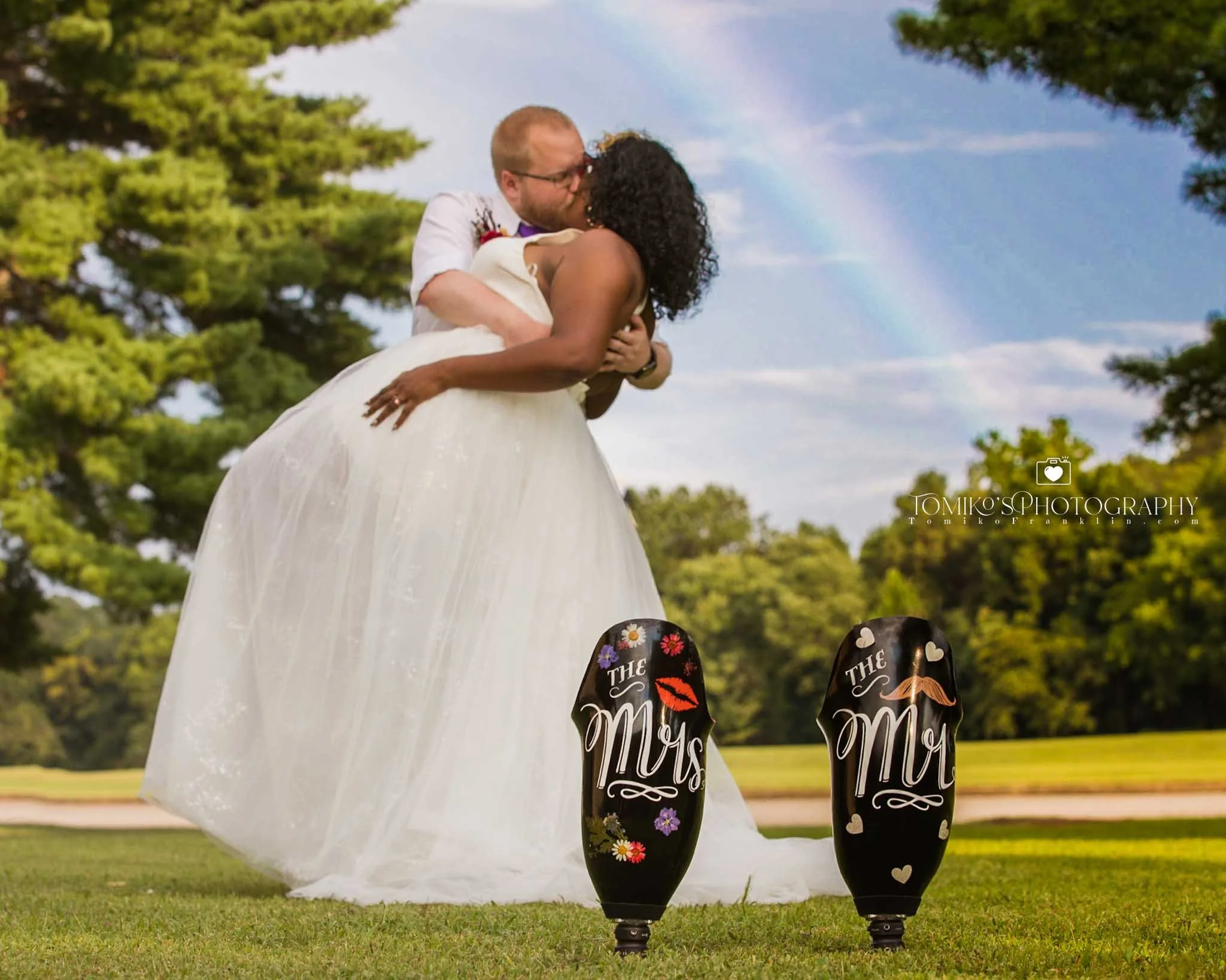 Bride and groom sharing a romantic dip‑and‑kiss during their Birmingham, Alabama wedding, captured by Tomiko’s Photography with elegant, editorial‑inspired wedding artistry.