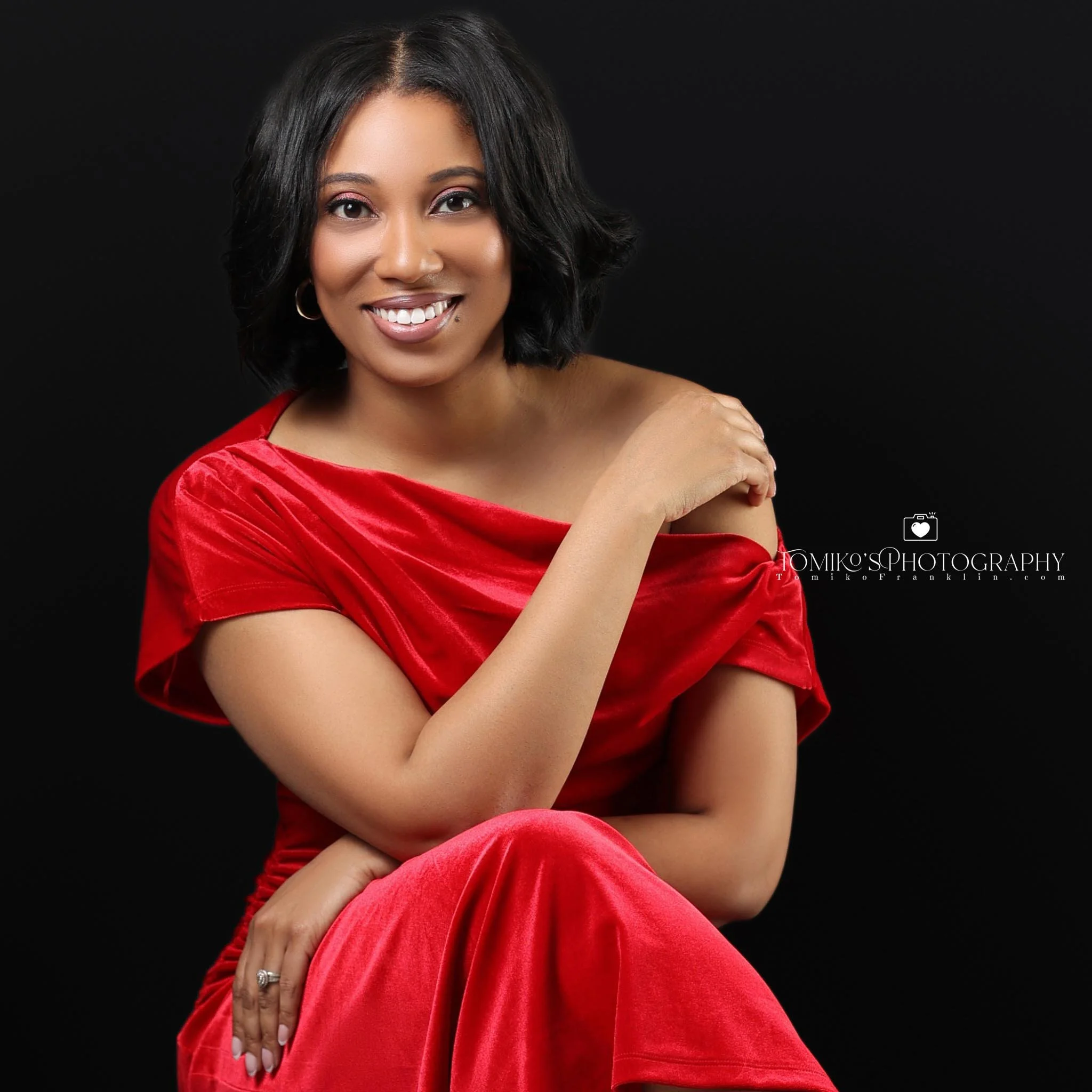 A glamour portrait of a beautiful woman taken at Tomiko's Photography studio in Birmingham, Alabama, featuring a black background.