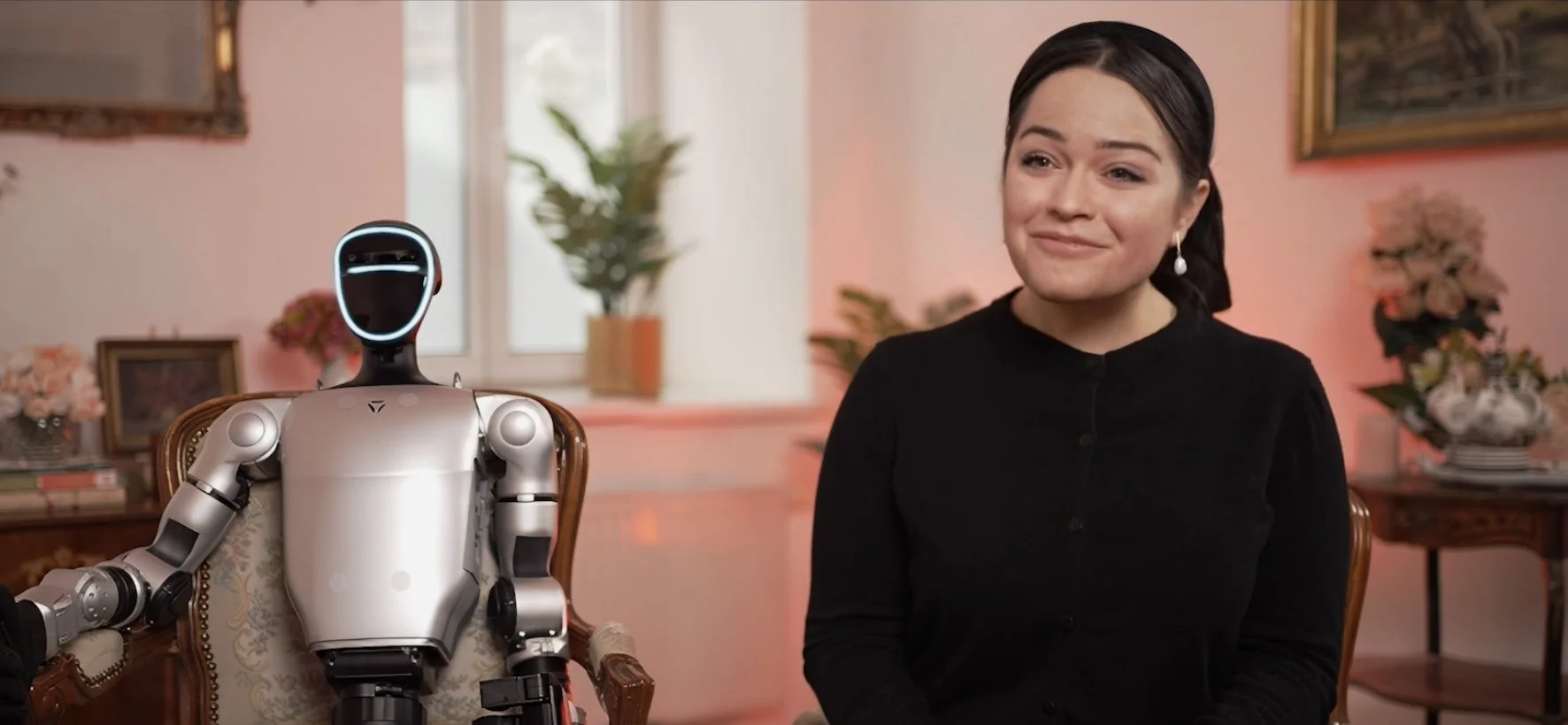 woman sitting with robot for interview