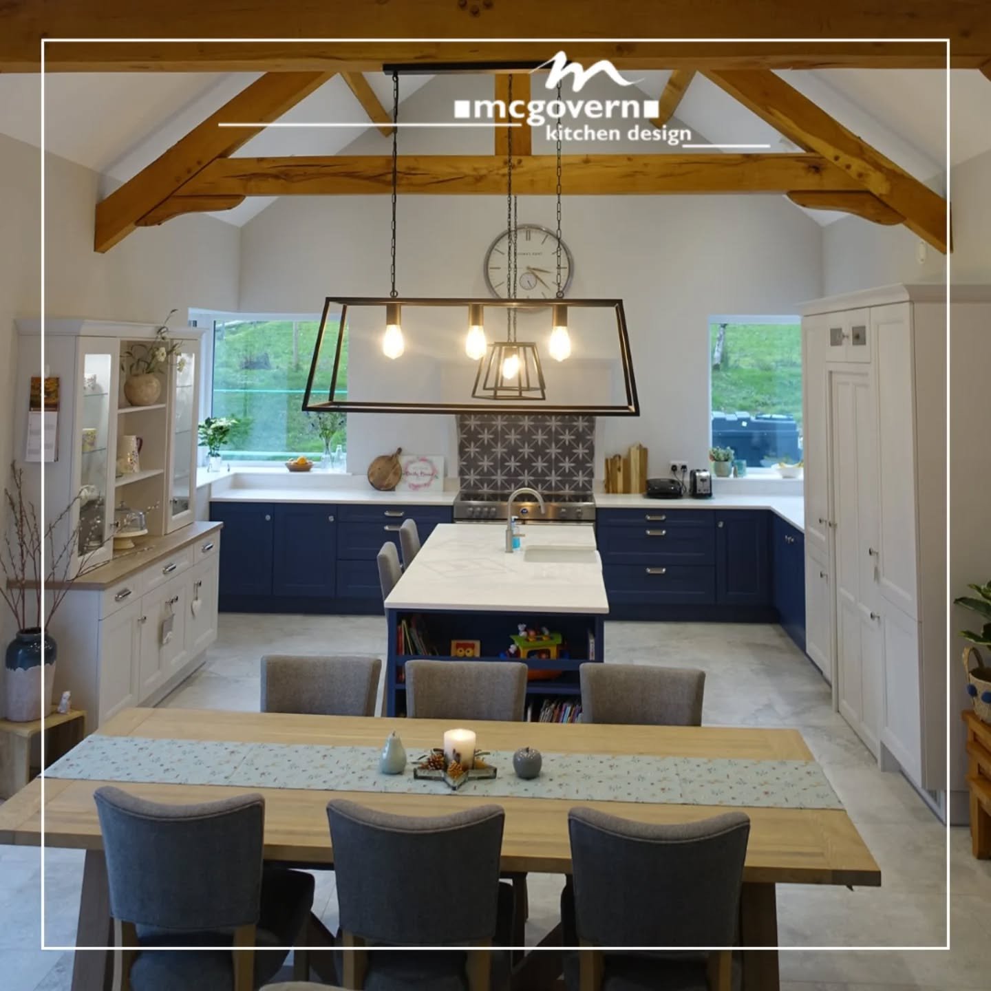 Flashback to this stunning project! 💙 This timeless family kitchen remains a favourite, showcasing rich blueberry and Manor Stone cabinetry, a striking tiled backsplash, and a traditional Belfast sink. With its open shelving, walk-in pantry, and cla