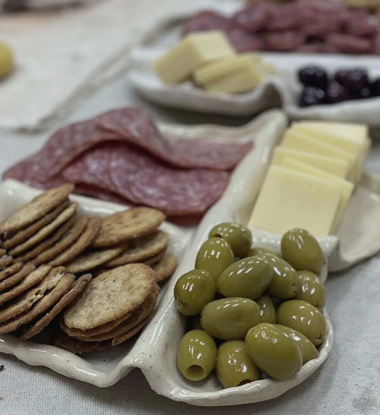 A handmade charcuterie board is full of yummy snacks.