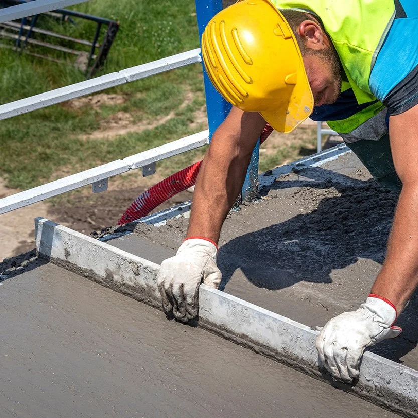 Construction man laying down concrete