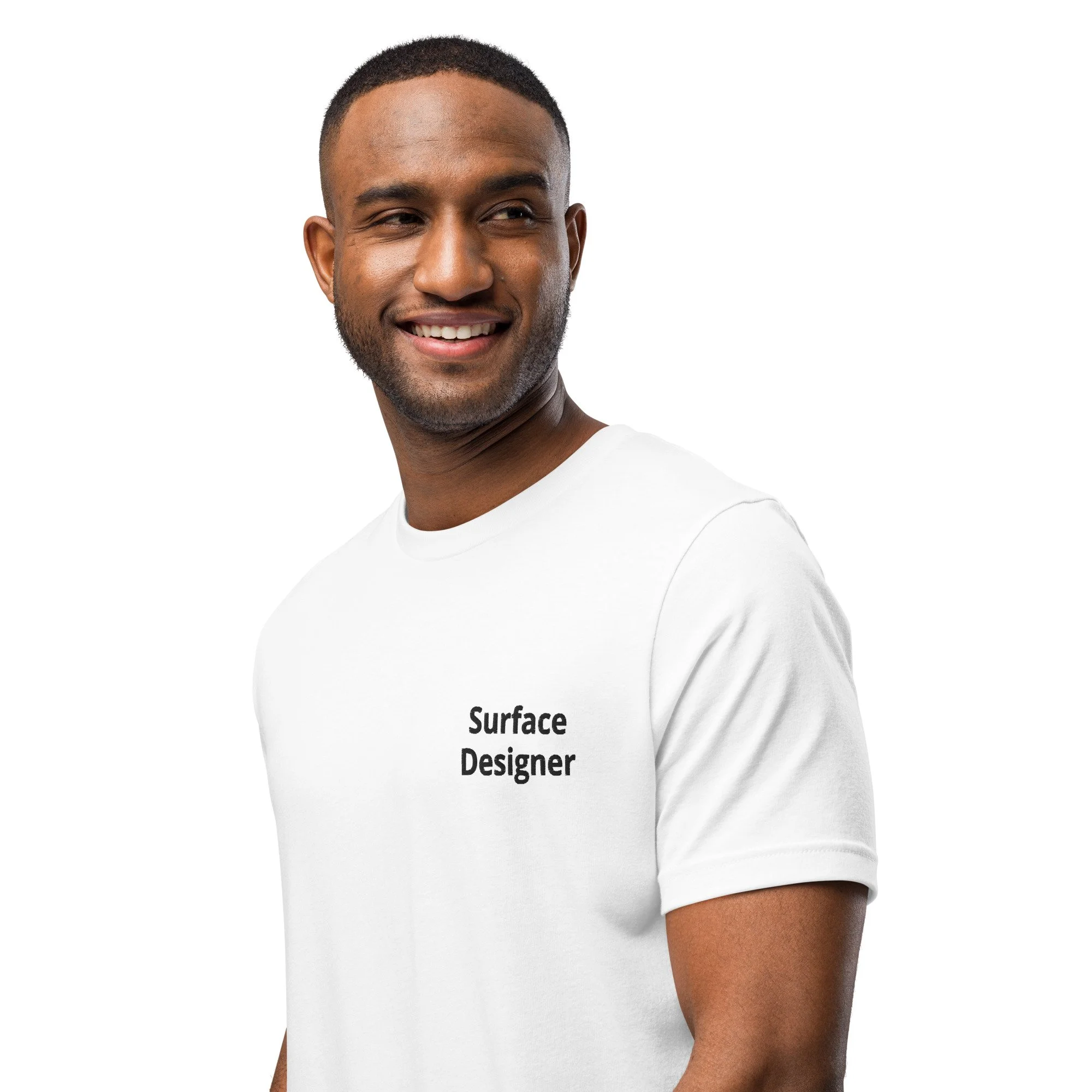 Person wearing a white t-shirt with 'Surface Designer' text, smiling.
