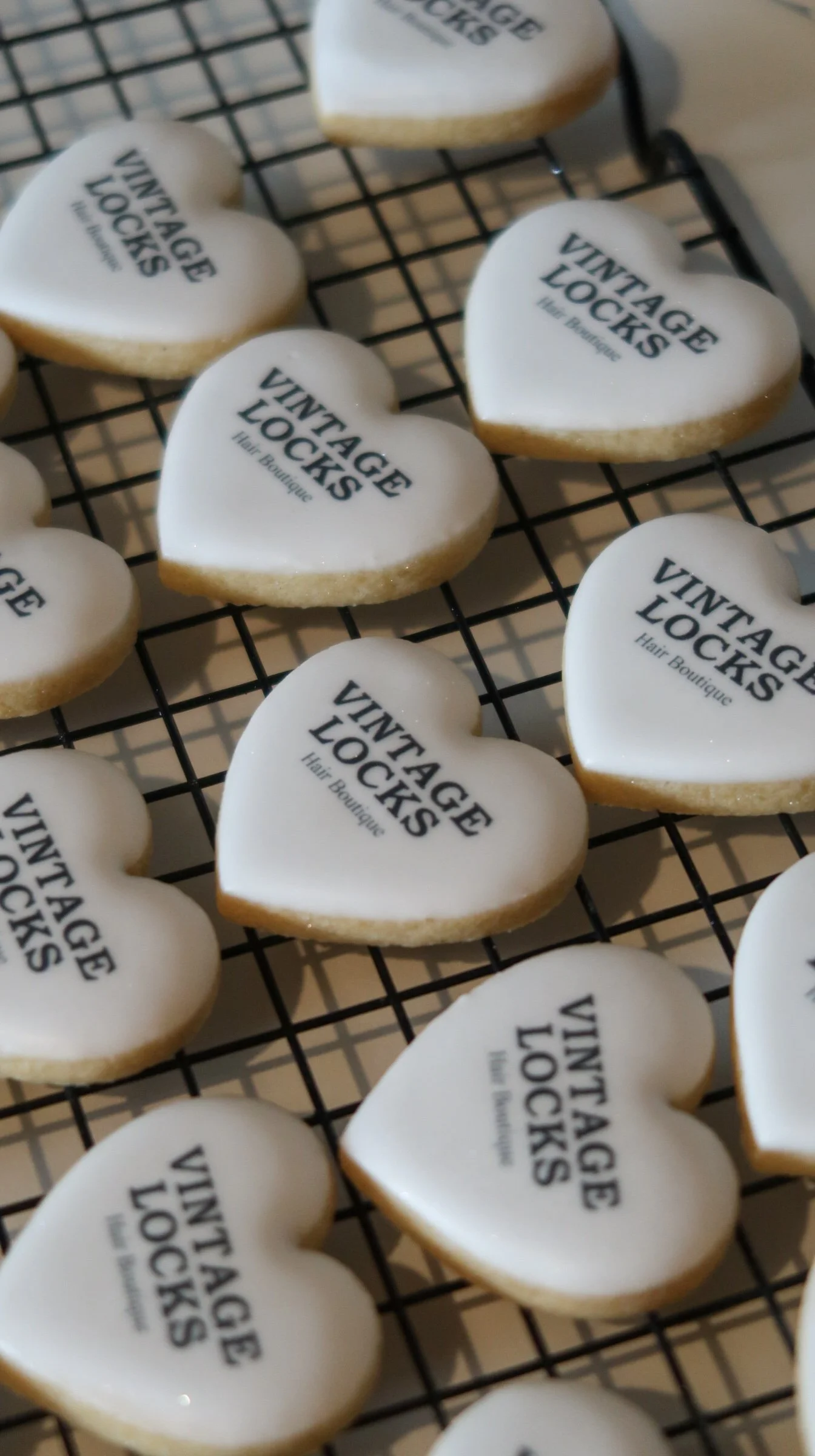 White heart shaped cookies with vintage locks logo