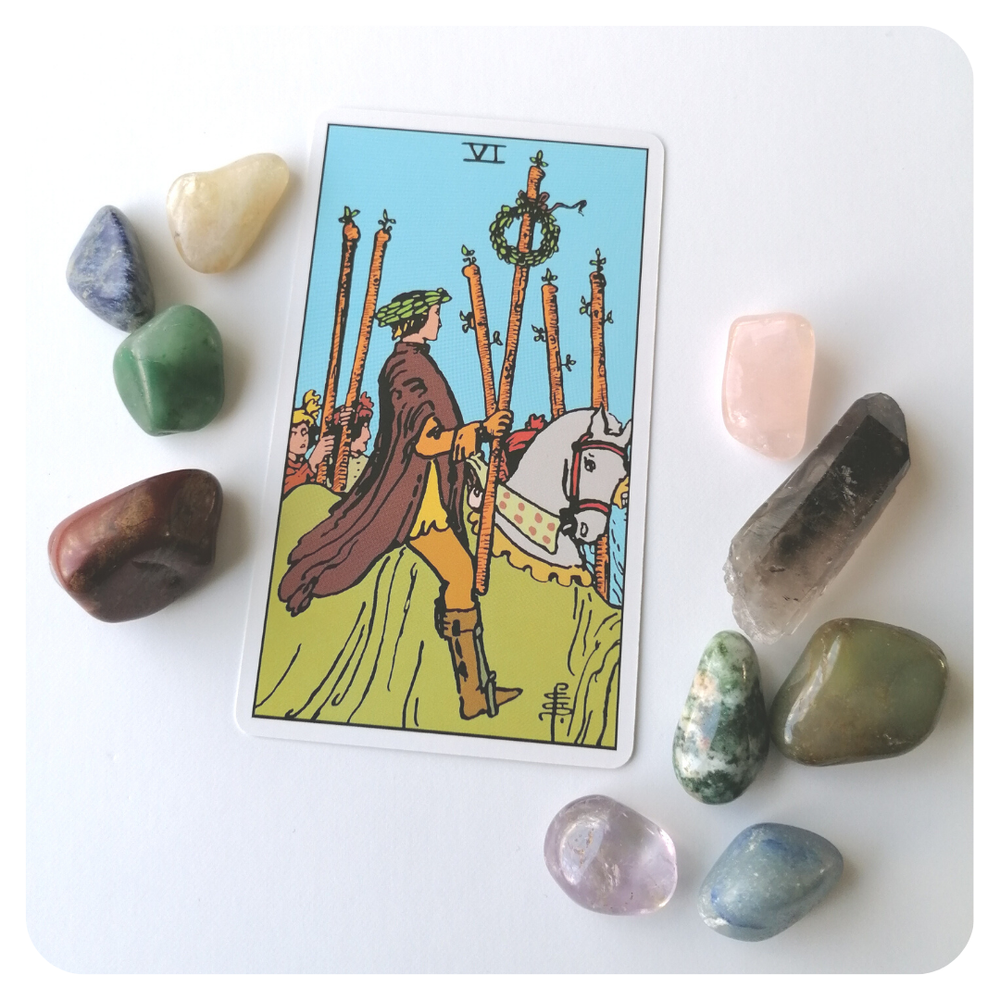 Six of Wands tarot card depicting a triumphant figure on a horse with a laurel wreath