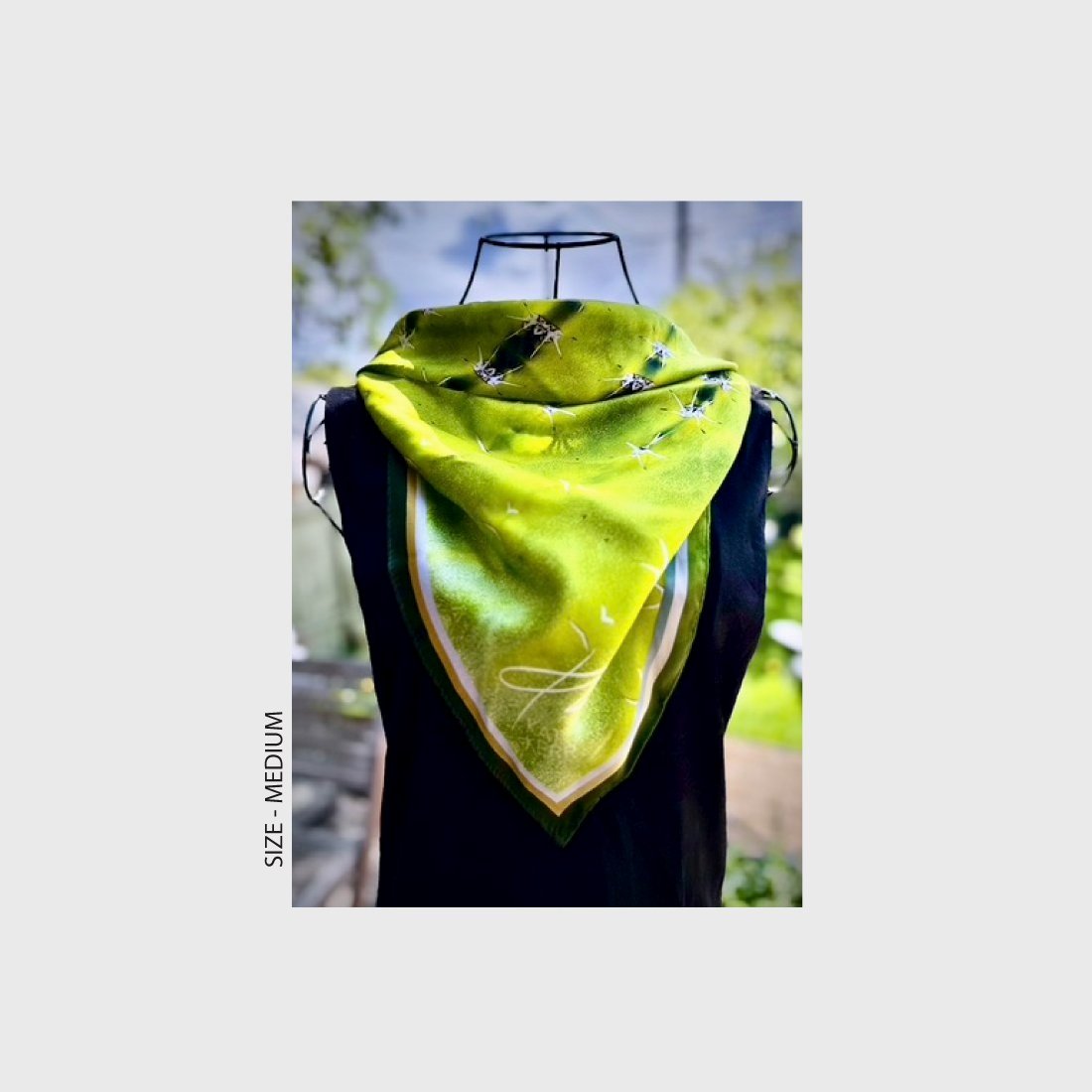 Mannequin wearing "Diversion" silk scarf, size either medium or large, hanging in down the front of a black sleeveless dress