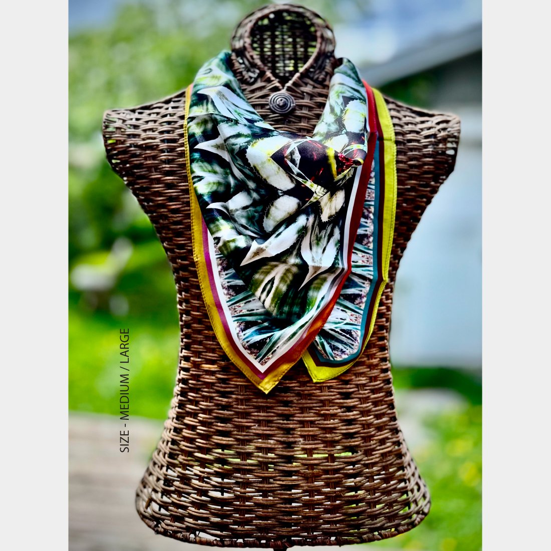 Wicker mannequin dressed with "Metamorphosis" silk scarf, sized large draped across its chest..