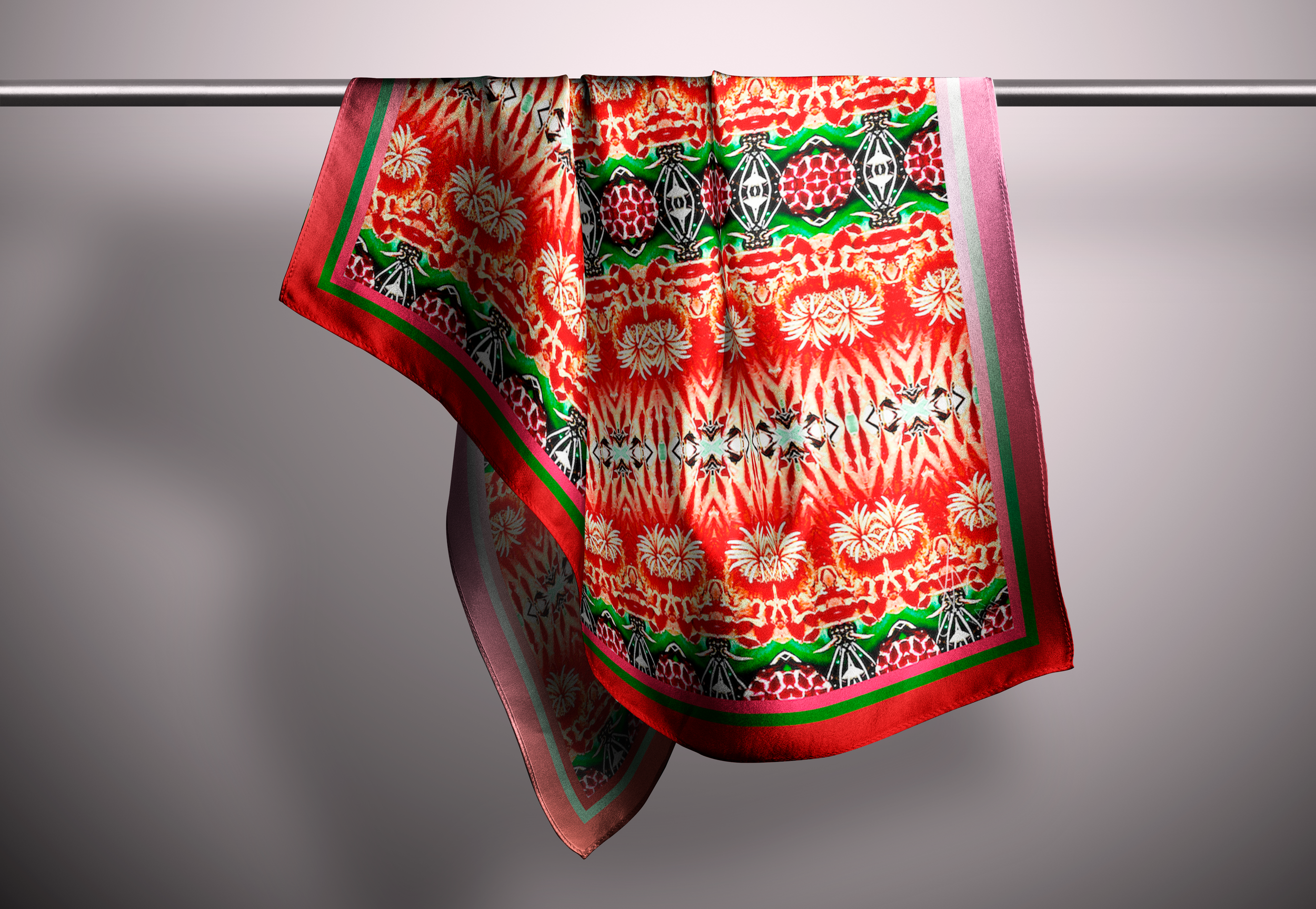 an image of a red flowered scarf hanging against a plain light backgorund