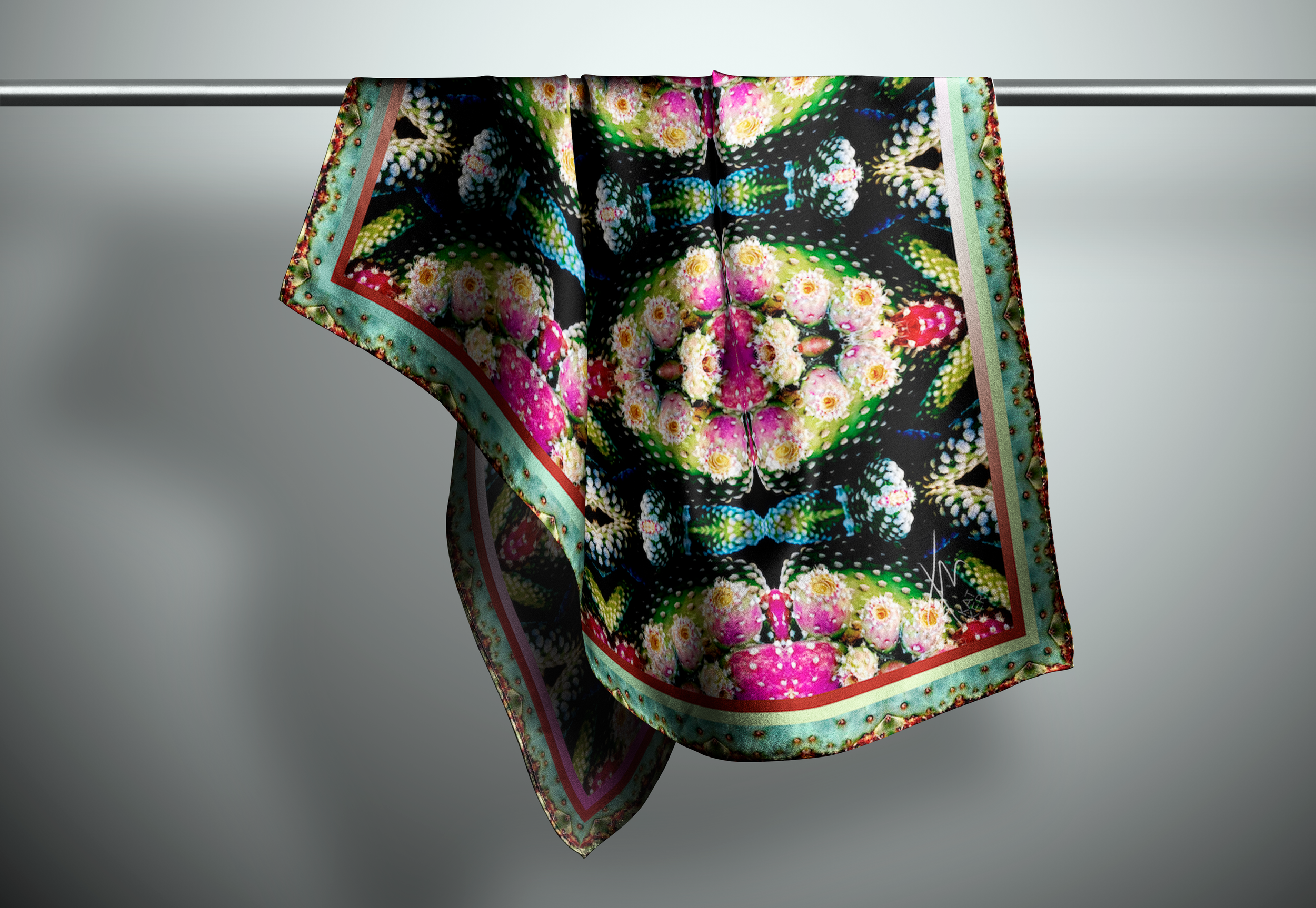 a drak and pink scarf hangs on a rod in a lightly lit room