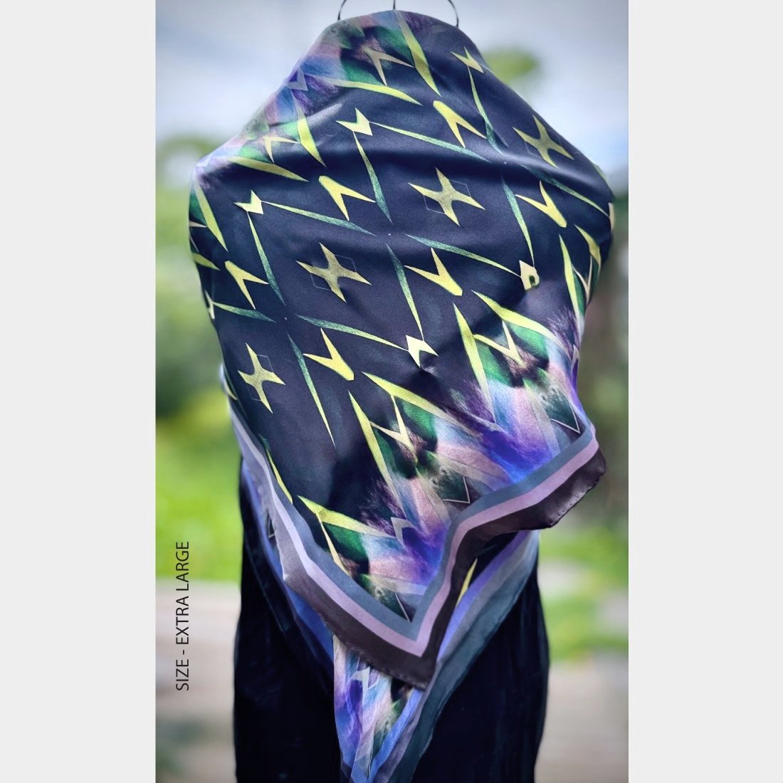 "Centuries of Healing" silk scarf size extra large is wrapped around a wire mannequin like a shawl.