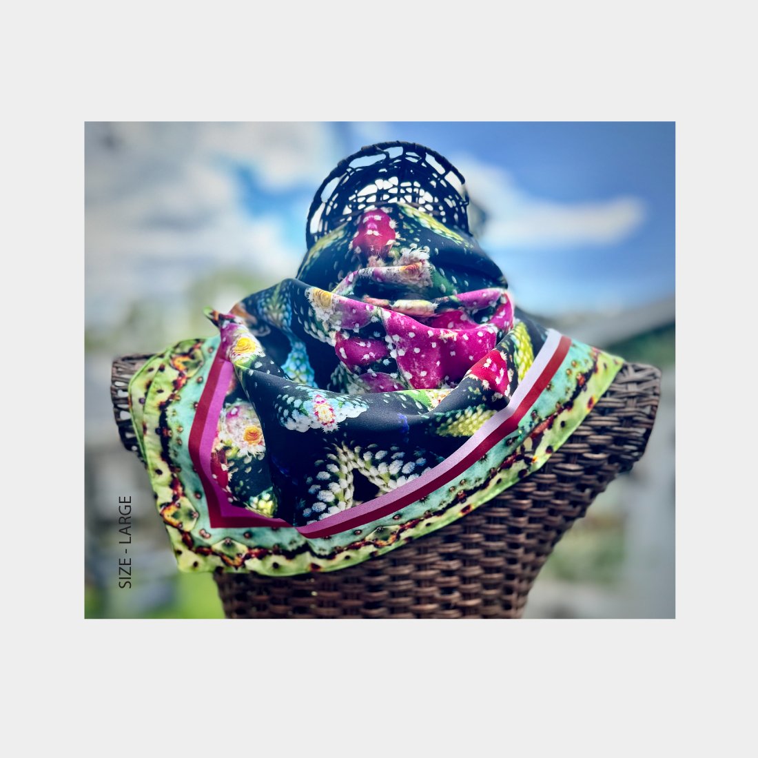Wicker mannequin dressed with "Exotic Fruit" silk scarf draped diagonally across its shoulders.