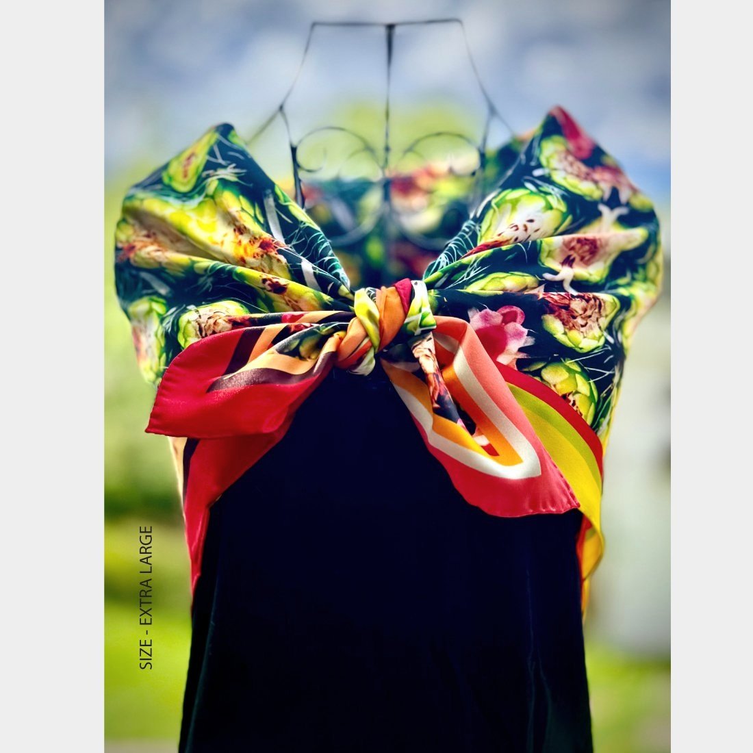 "Web of Life" in size extra large is gathered on a wire mannequin and tied in a bow over a black dress bodice.