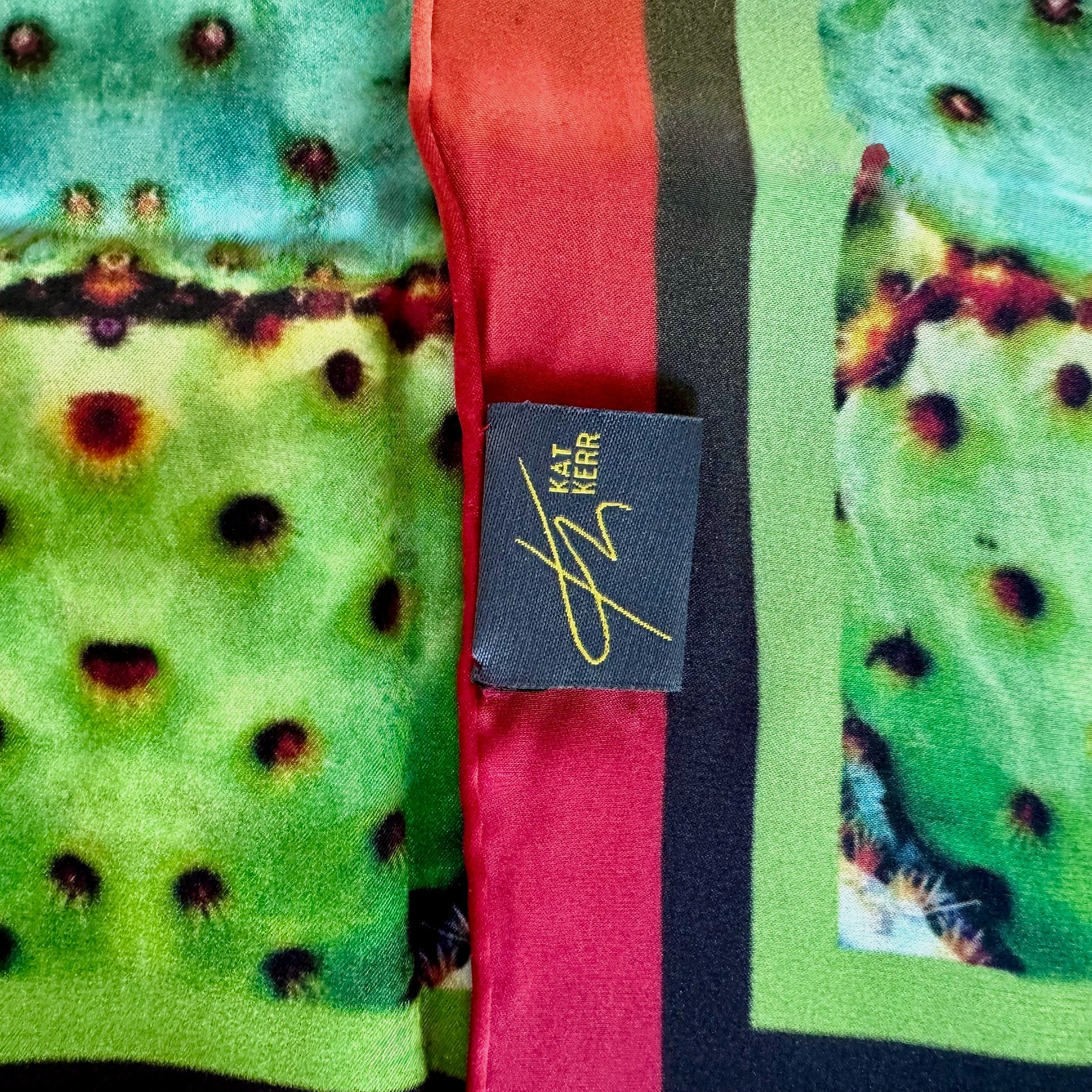 Detail of "Like Beadwork" silk scarf edge showing hand stitching, double sided printed, texture, logo and label