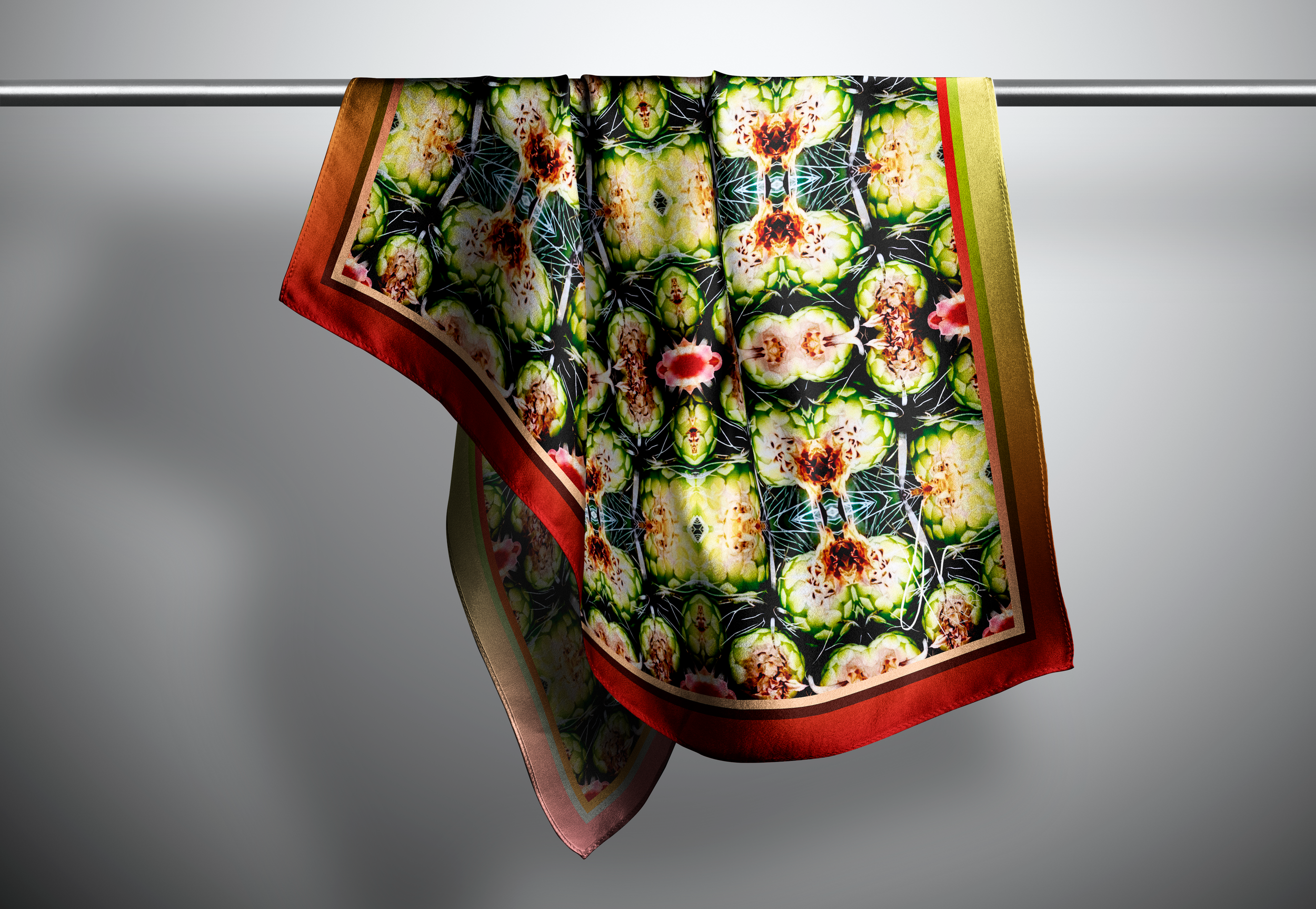 A stunning primary coloured patterned scarf hangs on a rod in a grey space.