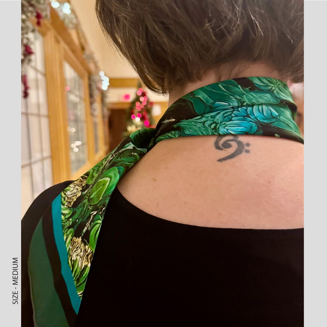a woamn wearing "the Water carriers" in size medium tied around her neck.