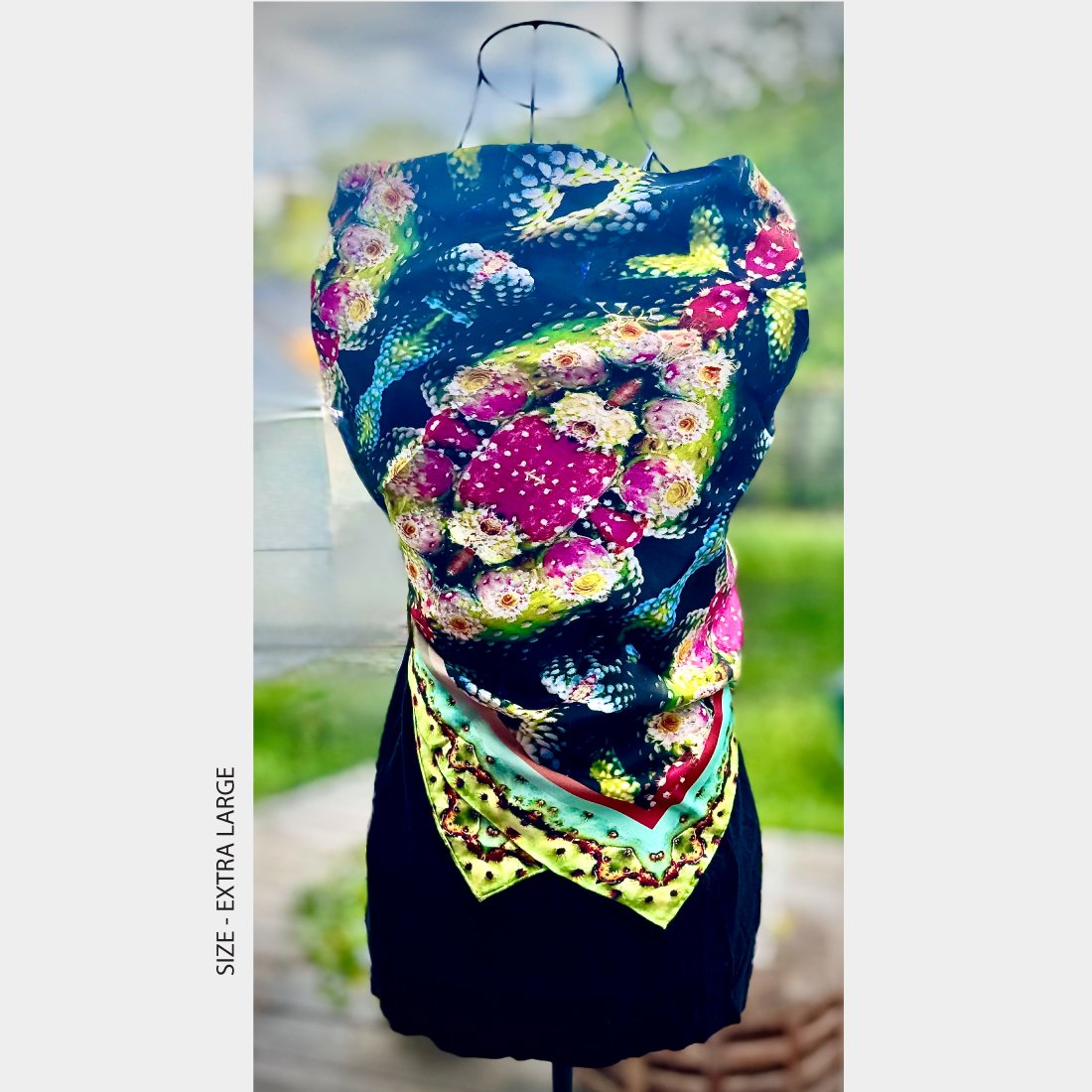 Mannequin wearing "Exotic Fruit" silk scarf, size extra large, tied like a dinner dress over a black sleeveless top