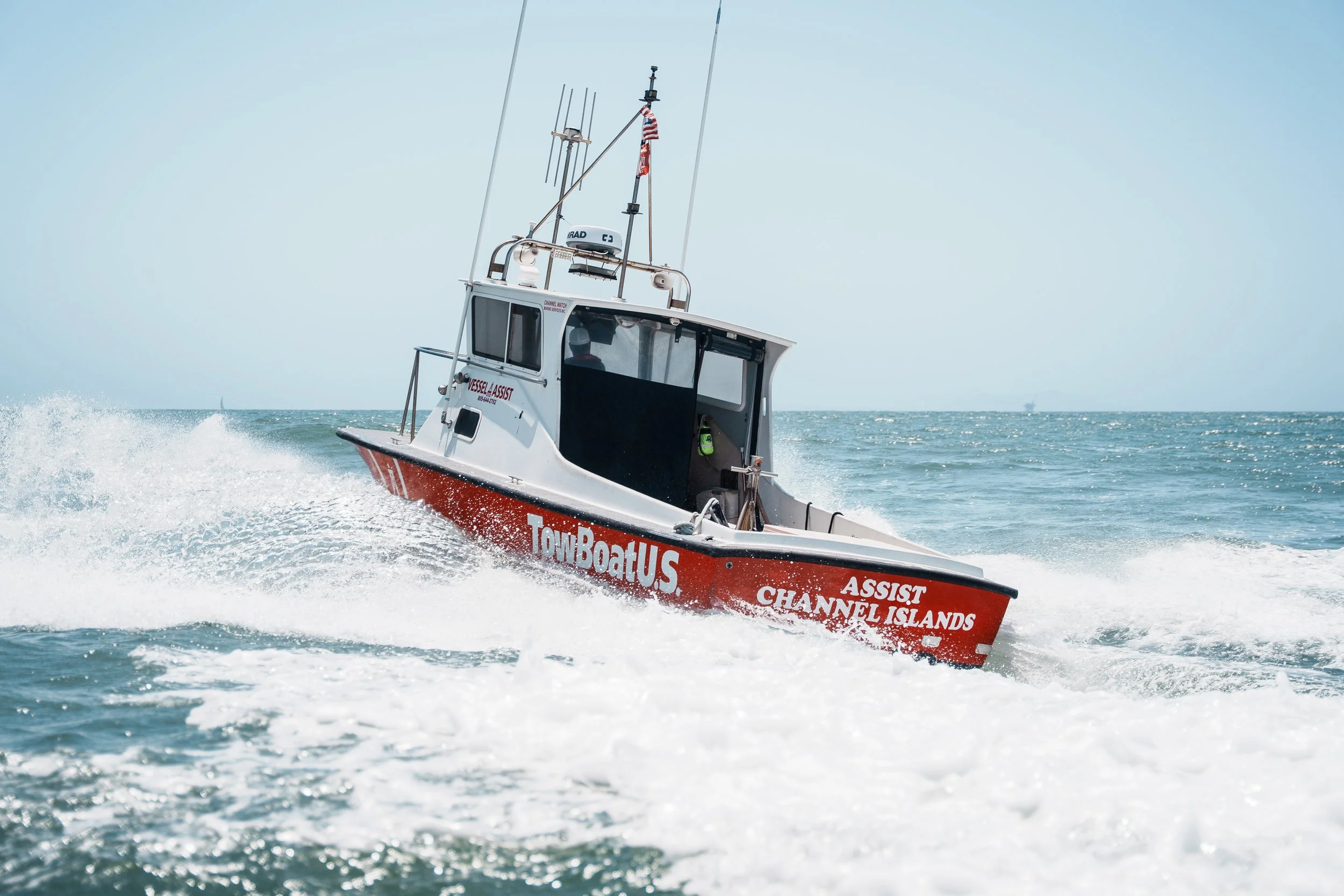 A rescue boat speeding across the water, marked with 'TownBoatUS' and 'Assist Channel Islands'.