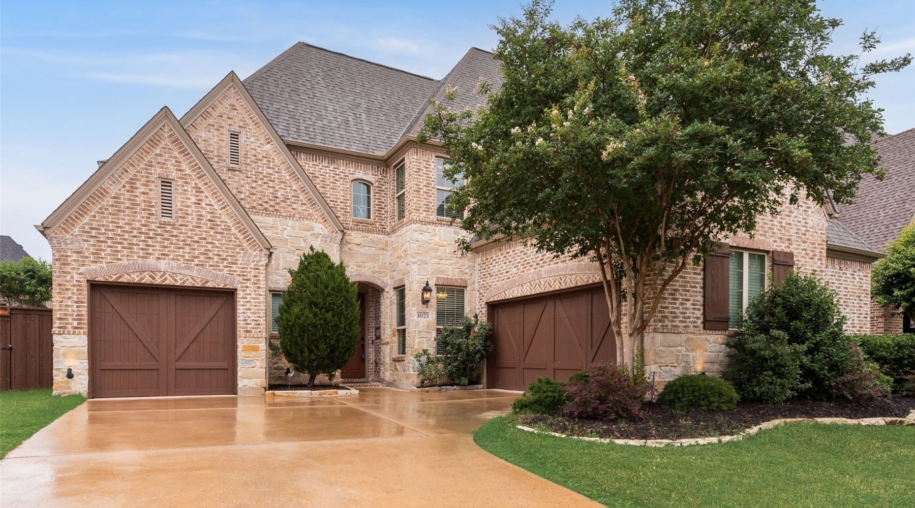 Front exterior of a luxury brick home sold by Lily Moore in Roanoke, Texas