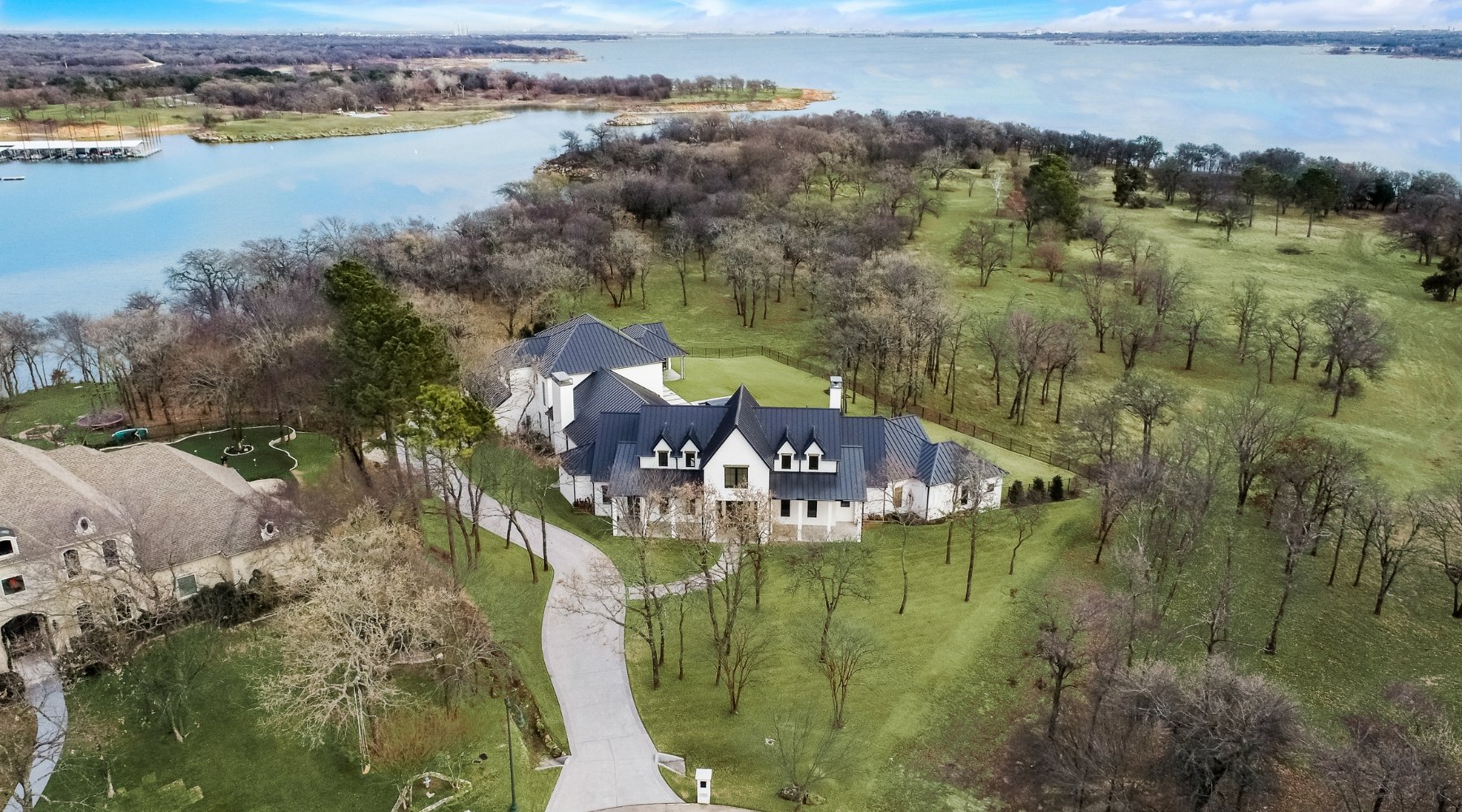 Aerial view of a luxury home sold by Lily Moore in Flower Mound, Texas, on a large wooded lot near the lake