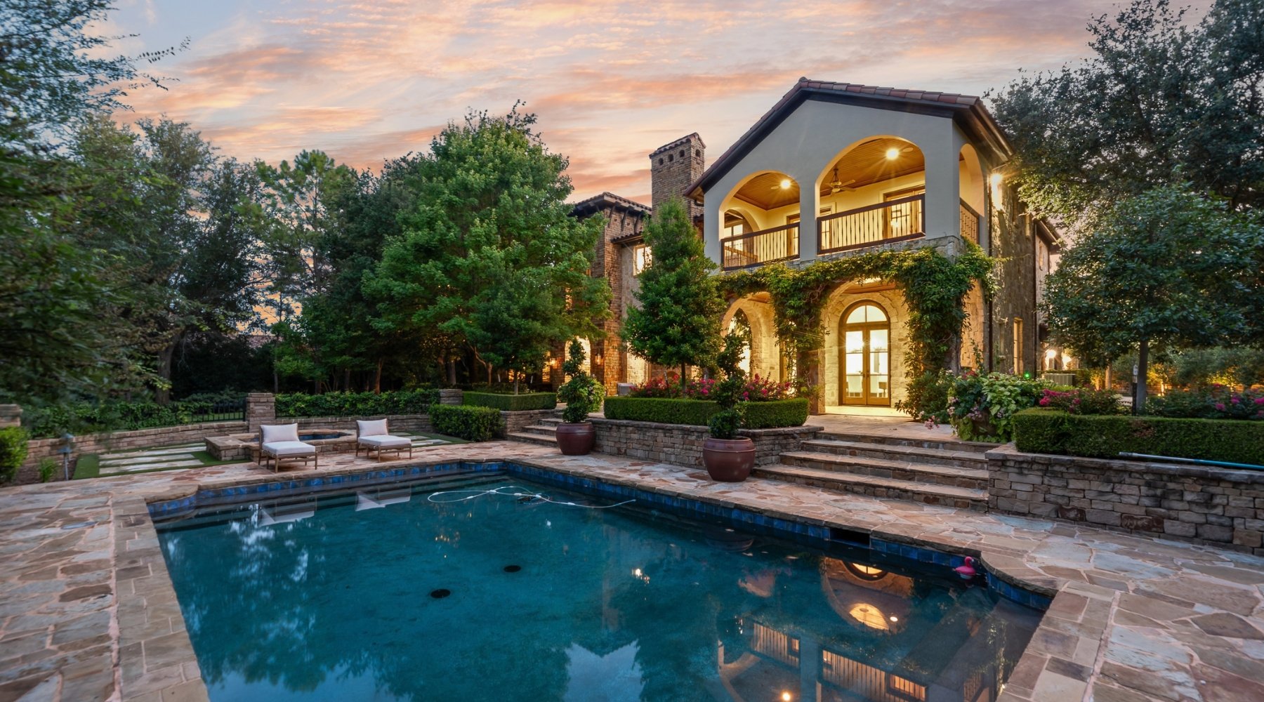 Twilight pool and rear exterior of a luxury home sold by Lily Moore in Westlake, Texas