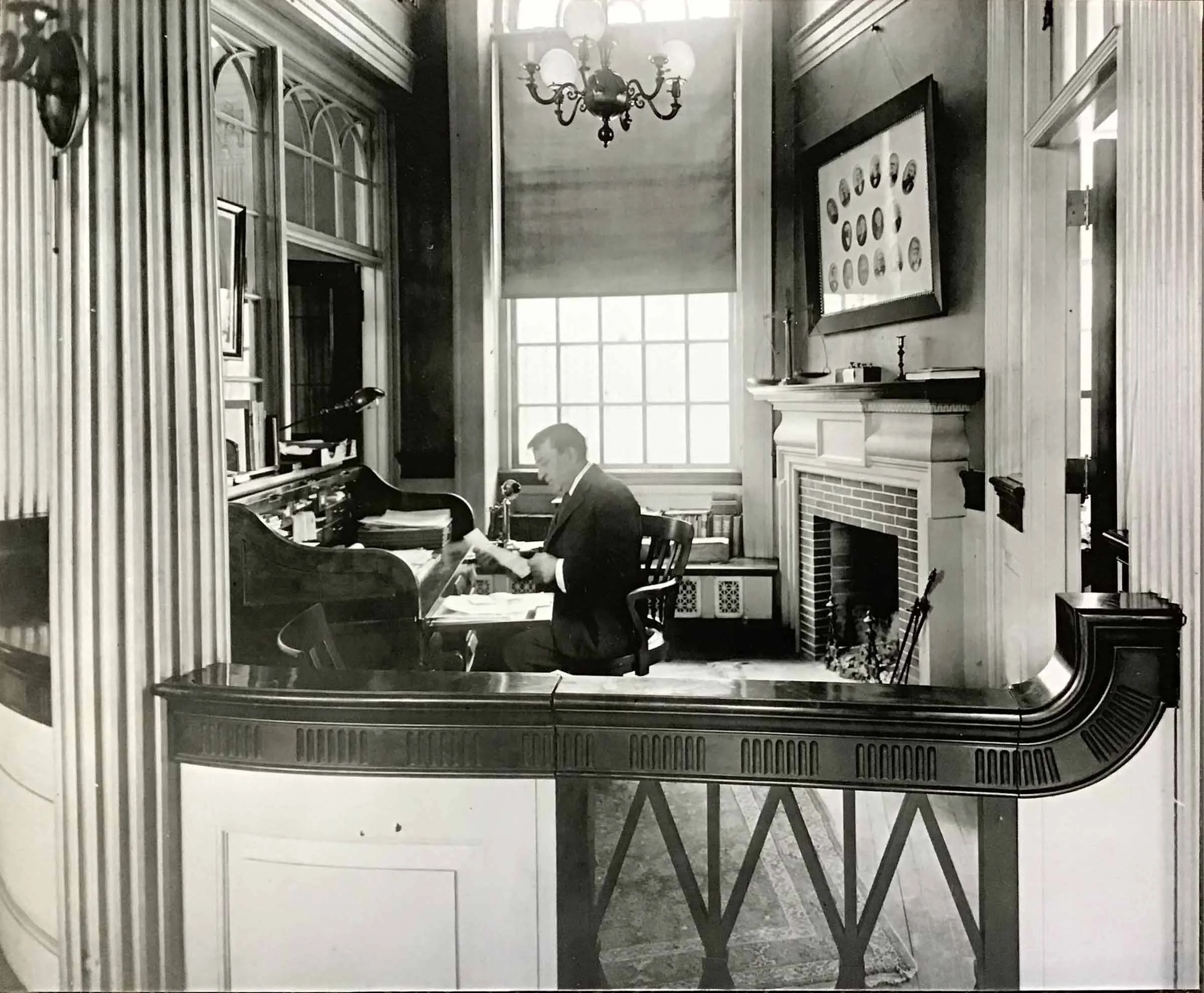 Photograph (circa 1935-1940) of the interior of the Industrial Trust Bank, Main St., Warren, RI, by Henry Cady. Features Edwin A. Cady at the desk.
