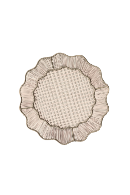 A decorative, circular plate with intricate detailing and a textured center, resembling vintage or ornate dishware.