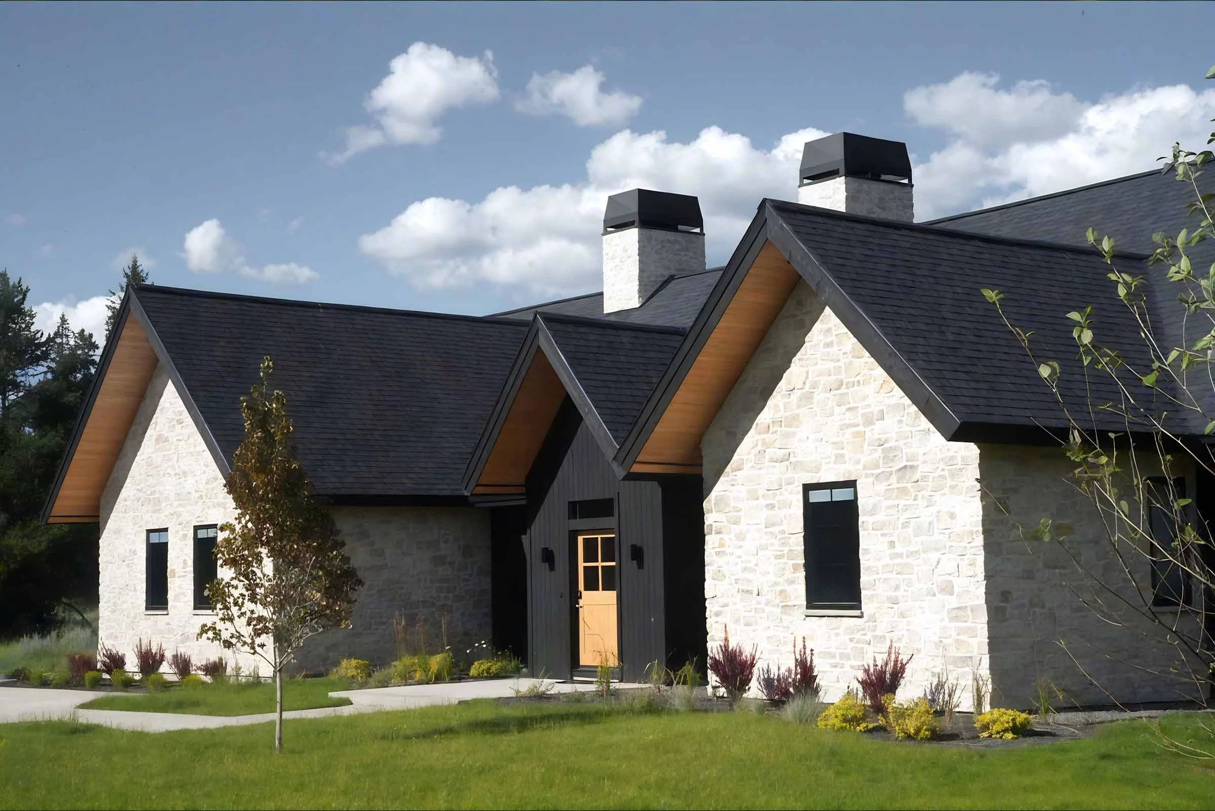 Stone-clad exterior of a high-end custom residence in McCall, Idaho, designed by Galczynski Studio with structural engineering by Plan North Engineers.