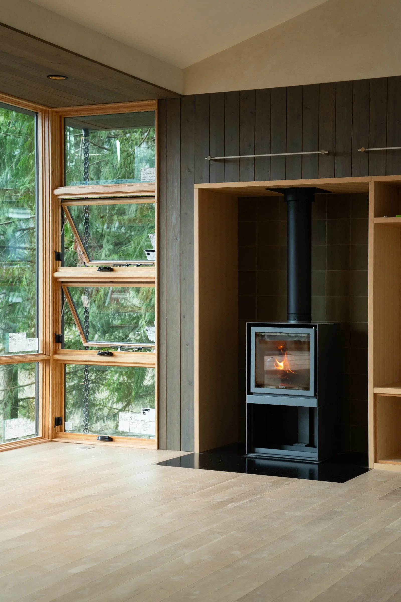 custom cabin in the woods of Bellingham Washington with nearby views of water extending to the Salish Sea. Architecture by PBW of Seattle with custom structural design by Plan North Engineers of Boise