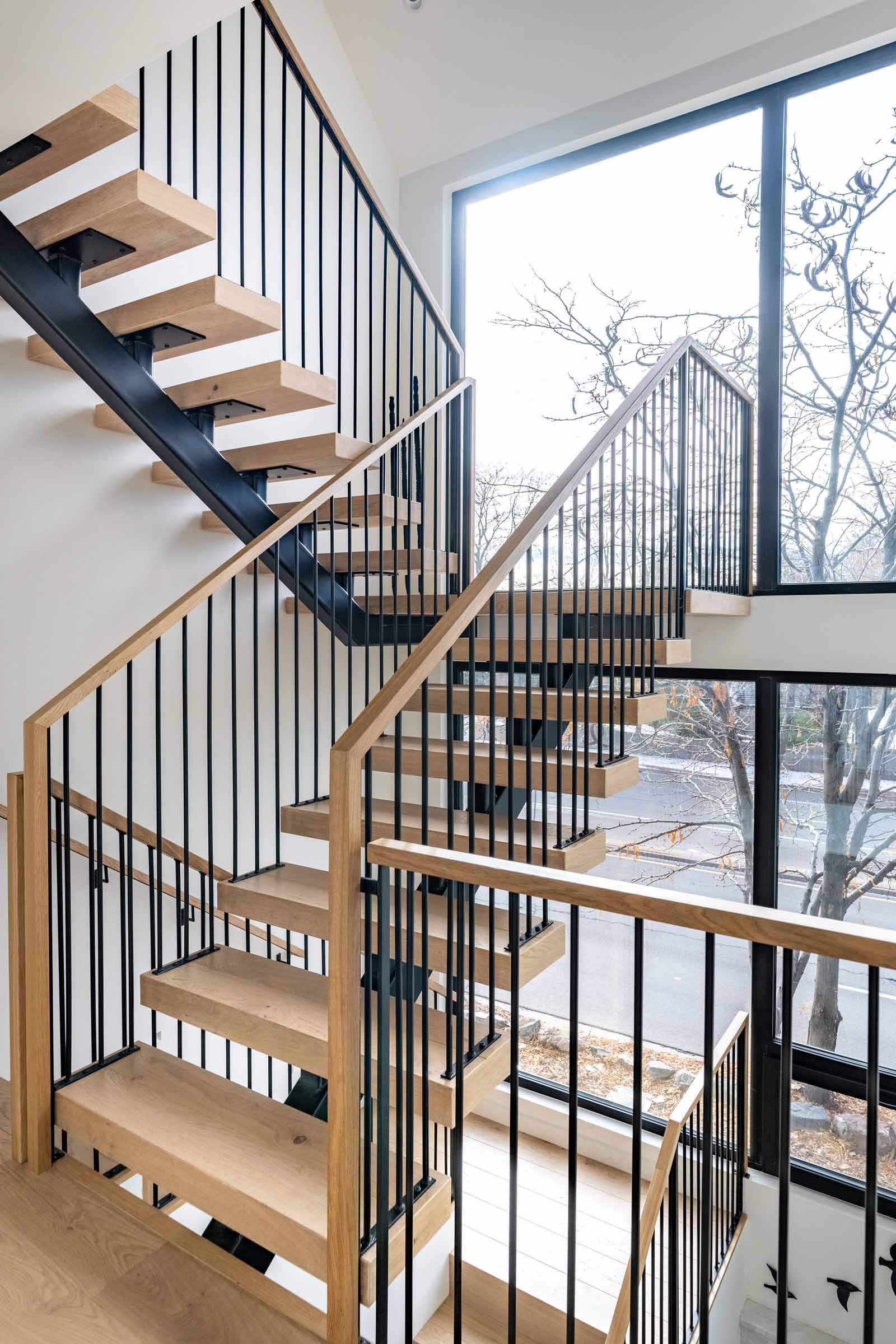 Custom steel-supported staircase engineered for modern residential design by Plan North Engineers