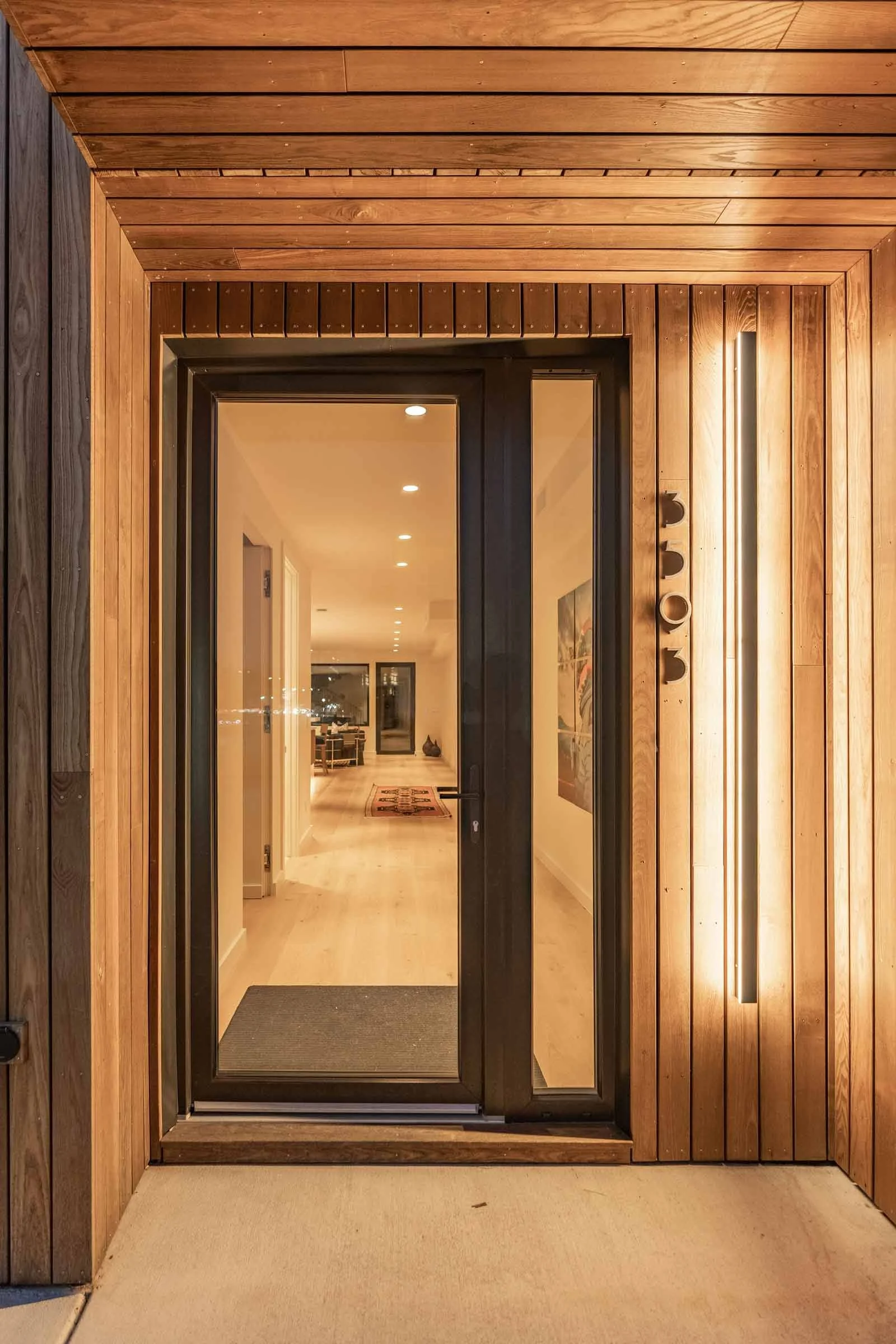 Wood-clad Passive House entry with high-performance structural detailing by Plan North Engineers