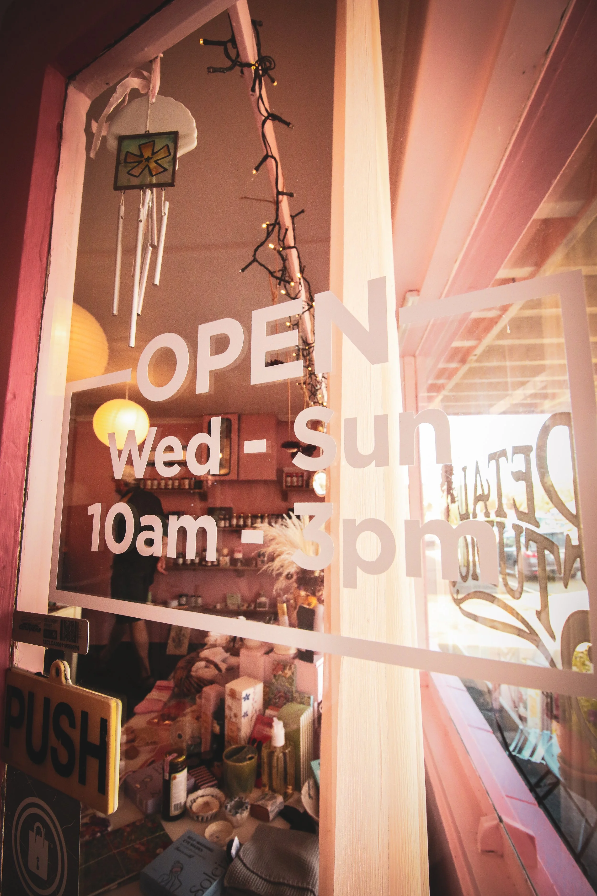 Petal Studio window with opening hours from 10am until 3pm