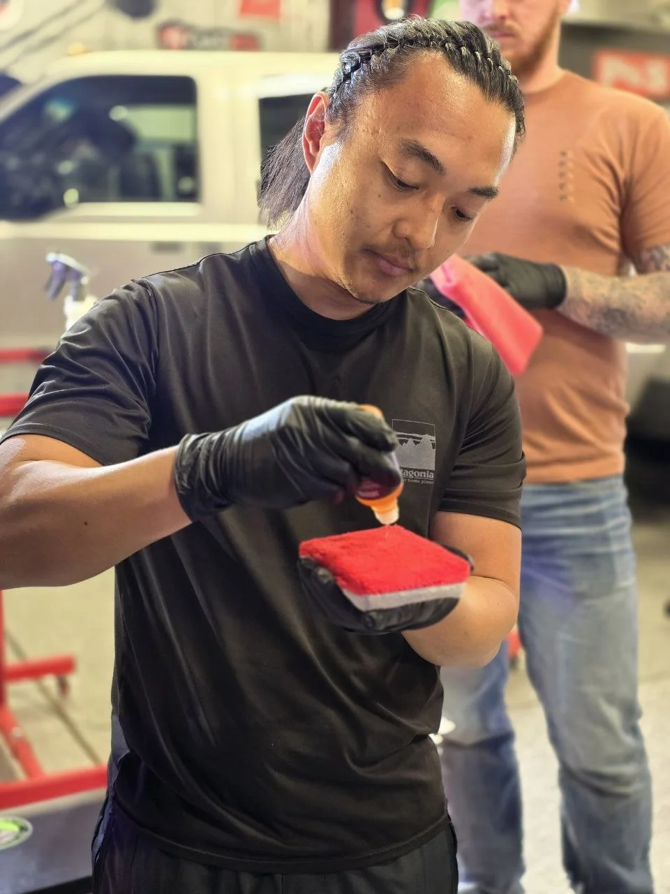 Detailer applying ceramic coating to 1991 Acura NSX