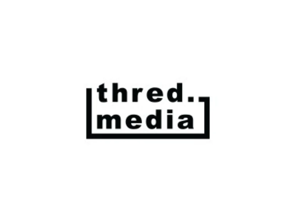 Logo with the words "thred. media" in black font, with "thred." above and "media" below, enclosed in a black rectangular border, on a white background.