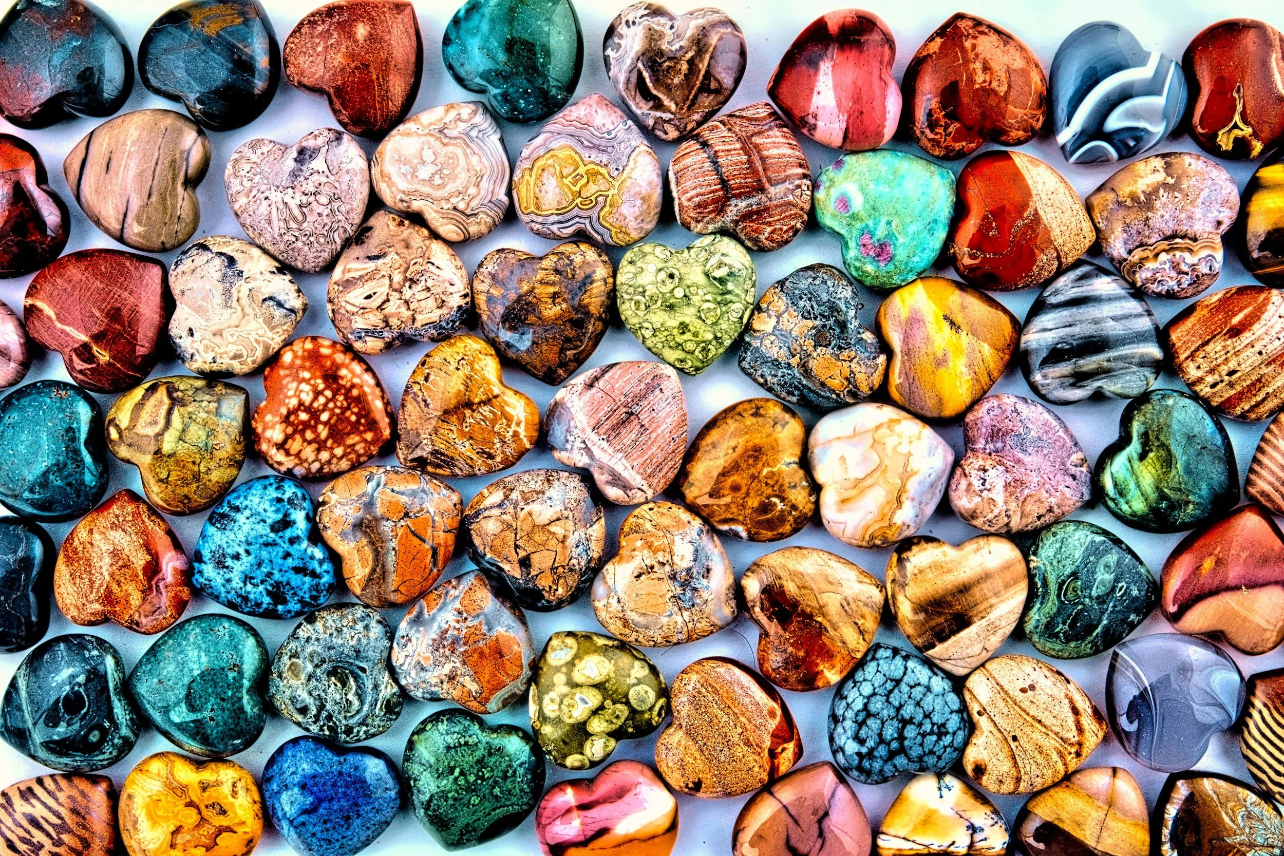A collection of polished, colorful semi-precious stones with various patterns and textures.