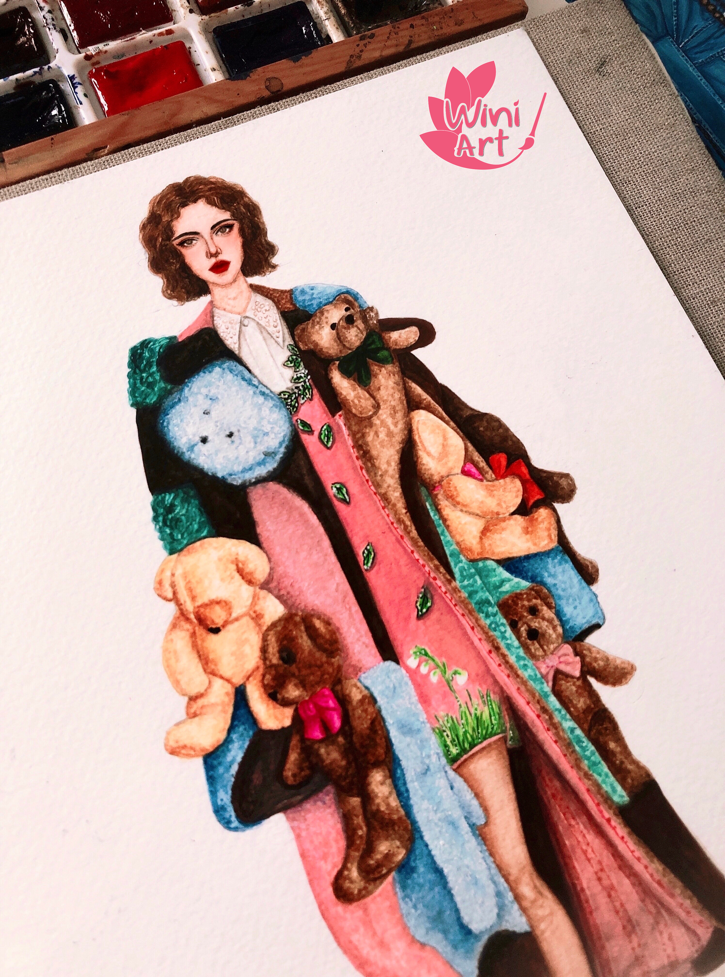 A watercolor illustration of a young woman with curly brown hair holding a collection of teddy bears. The illustration includes a pink banner with the text 'Wini Art' and a stylized leaf and paintbrush logo.