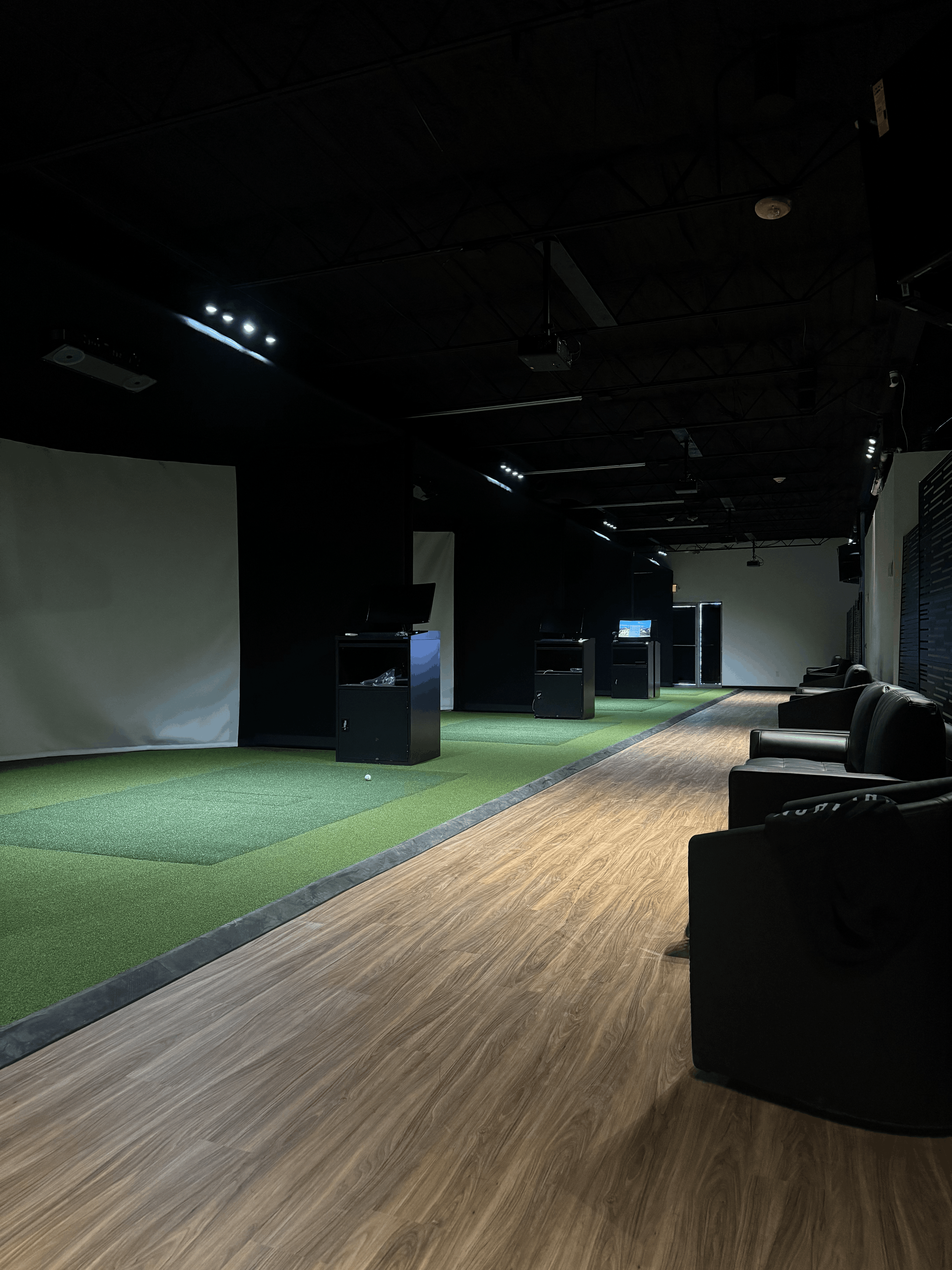 Indoor golf simulator bays at Birdie House Golf Club in Oklahoma City