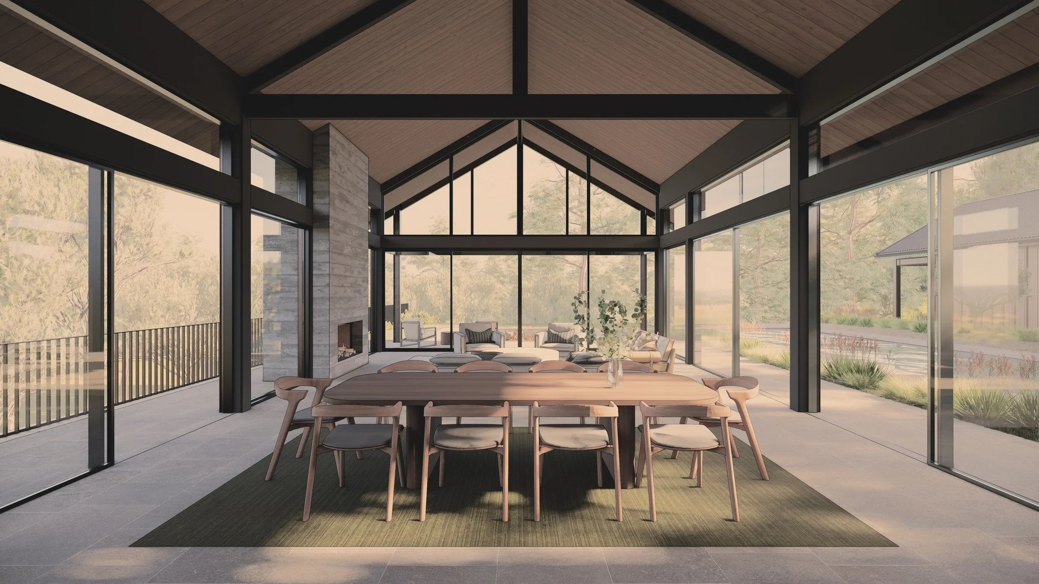 Dissolving boundaries: A dialogue between dwelling and nature in our Galston House. From the kitchen's vantage, the living areas extend seamlessly into the wide-ranging bushland. Expansive glass on three sides doesn't just frame views, it invites the